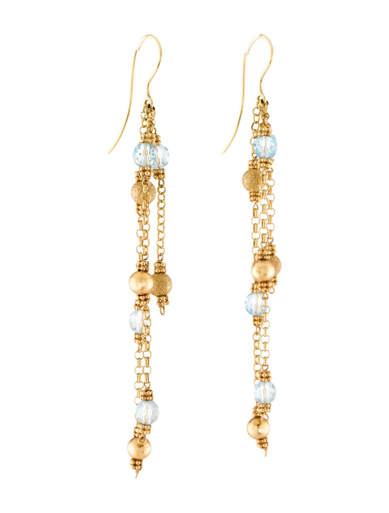 These playful dangle earrings are sure to add a pop of color to any outfit. Expertly crafted from 18 karat yellow gold, the earrings feature faceted blue topaz beads and textured gold beads in a combination of satin and sand finishes. The