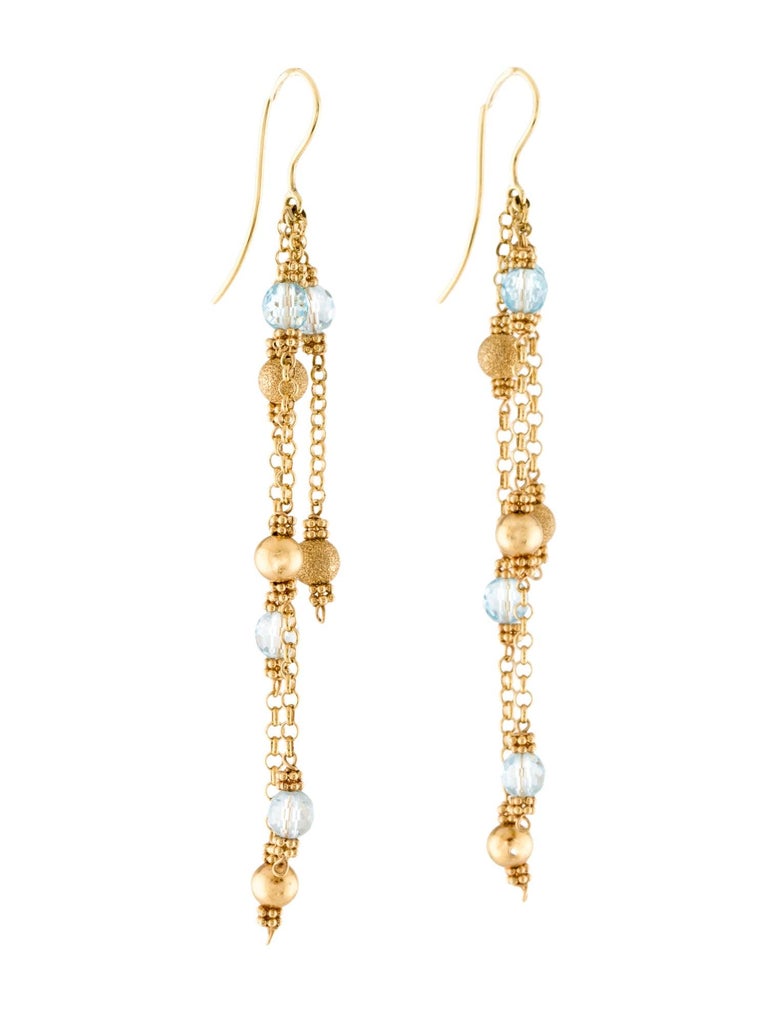 Playful 18 Karat Yellow Gold Blue Topaz Dangle Earrings, featuring Faceted Blue Topaz Beads, and a rich texture of gold beads in both satin and sand finish.  Length 3.5 inches width .5 inches. 