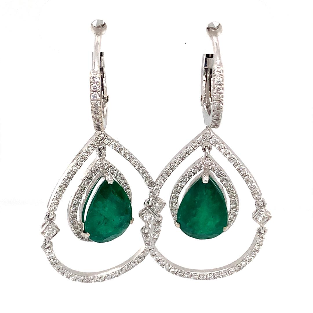 An stunning set of 18-karat white gold hoops earrings with 6.55-carat pear-shaped emeralds and 1.24-carat natural diamonds. 