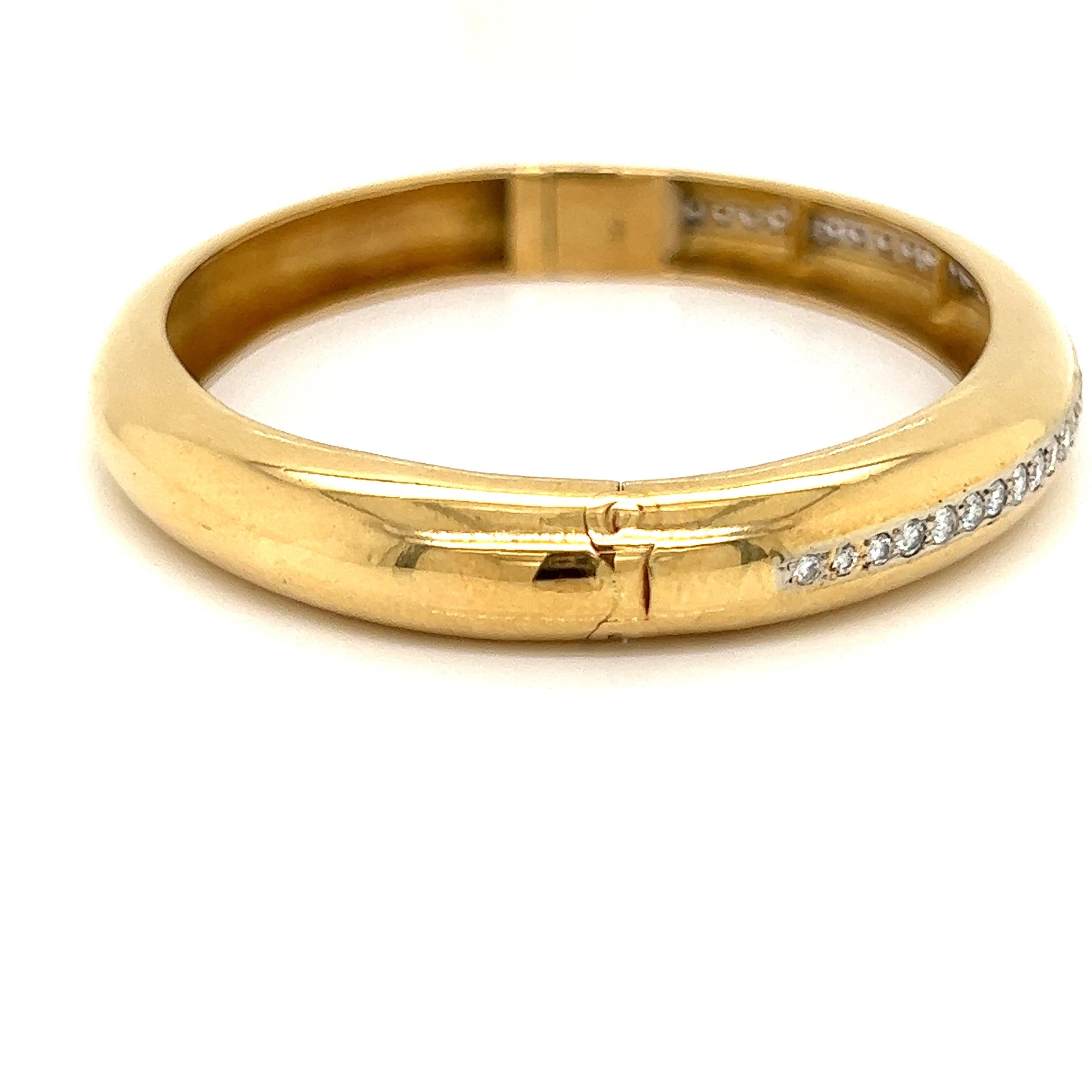 The perfect bangle for any outfit, 32.18 grams of 18 kt yellow gold and one cttw of VS-SI clarity diamonds with G-H color.  Perfect alone or stacked with a tennis bracelet.  This well made bangle is a bold classic that never goes out of style. 