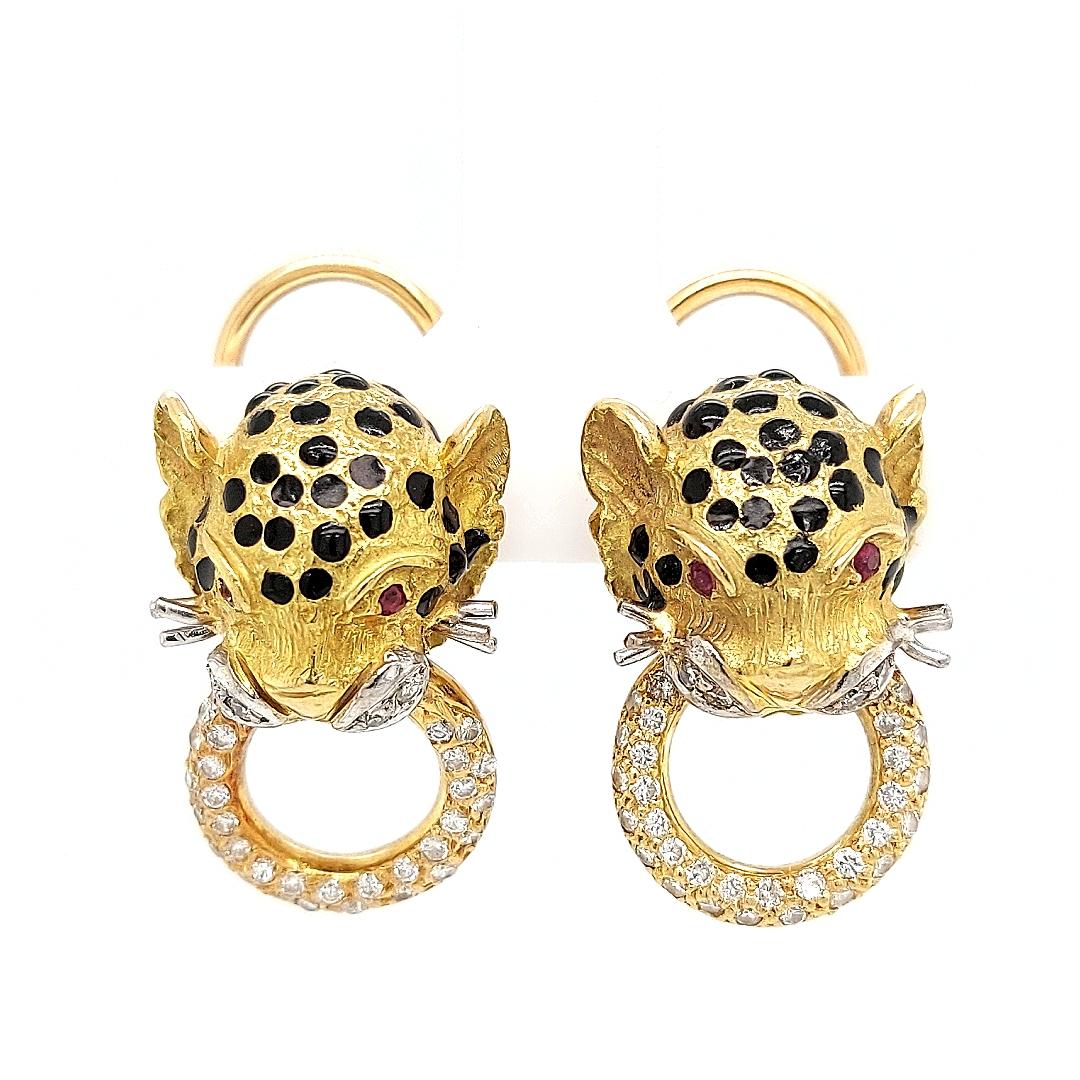 18kt Yellow Gold Panther Clip - On Earrings With Diamonds

Diamonds: 70 little brilliant cut diamonds

Ruby: 4 little rubies, together 0.04ct

Material: 18kt yellow gold

Total weight: 15.6 gram / 0.550 oz / 10 dwt

Measurements: 14 mm x 21.1 mm x