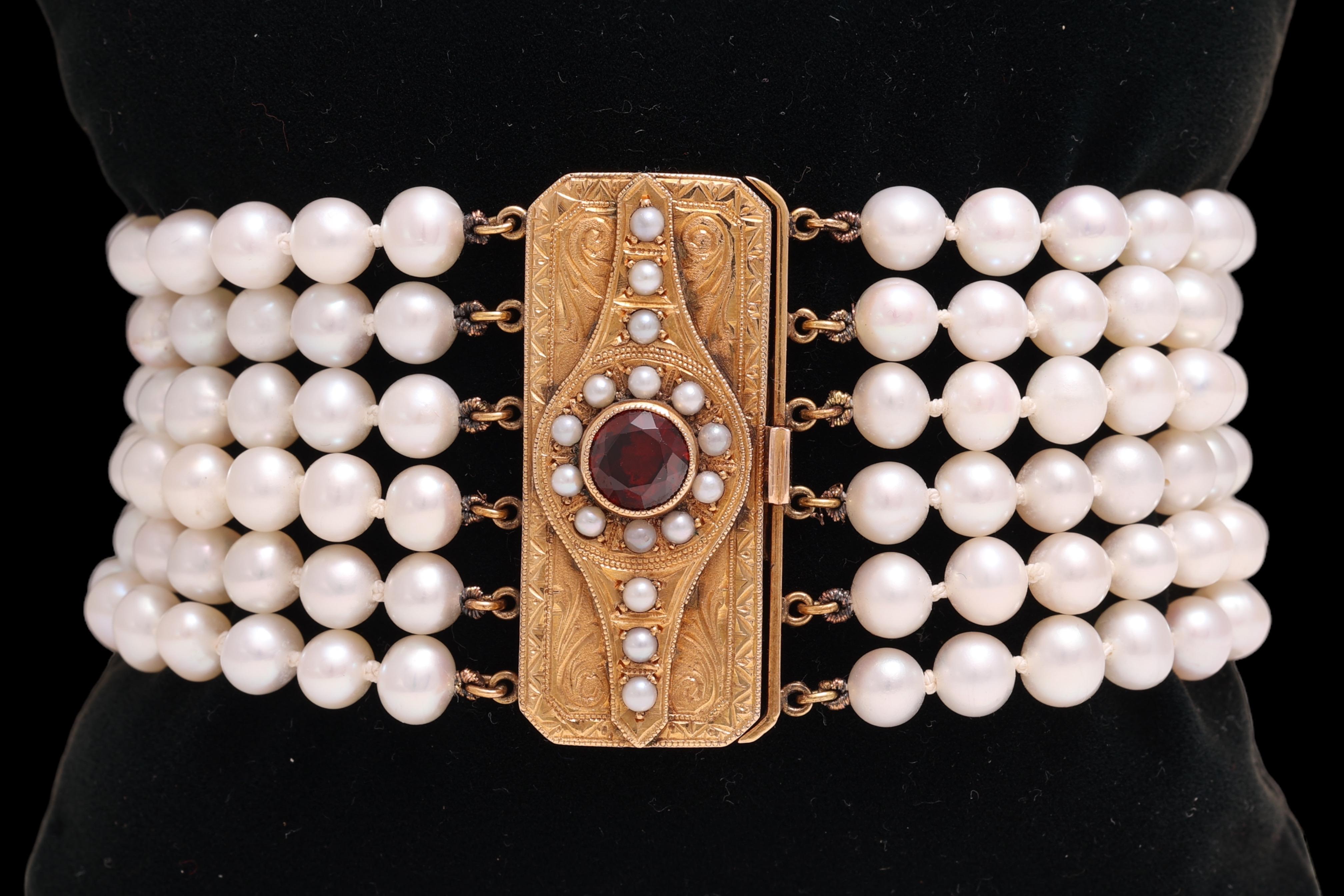 Beautiful Bracelet with 6 Rows of Japanese Akoya Pearls & Art deco Gold Locker with 1ct. Garnet 

Garnet: Red garnet stone 1 ct. 

Pearls: 174 pearls with diameter 6 mm, 16 mini pearls diameter 2.2 mm

Material: 18 kt. yellow gold

Measurements: 20