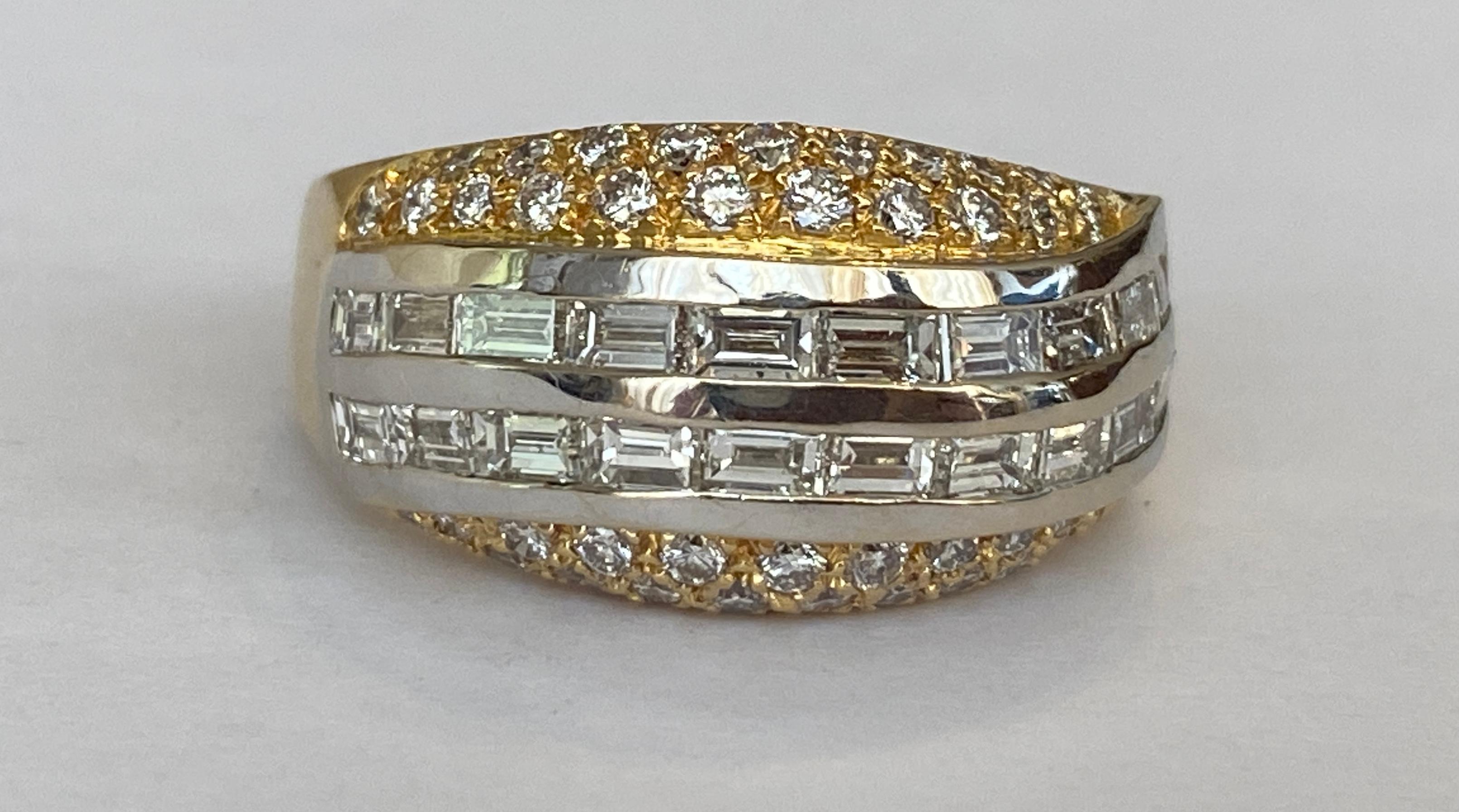 Offered in excellent condition is an 18 carat white and yellow gold band ring. The ring consists of three bands. The middle band is decorated with 20 pieces of baguette cut diamonds, approx. 1.58 ct G/VS and the other bands are set with 44 pieces of