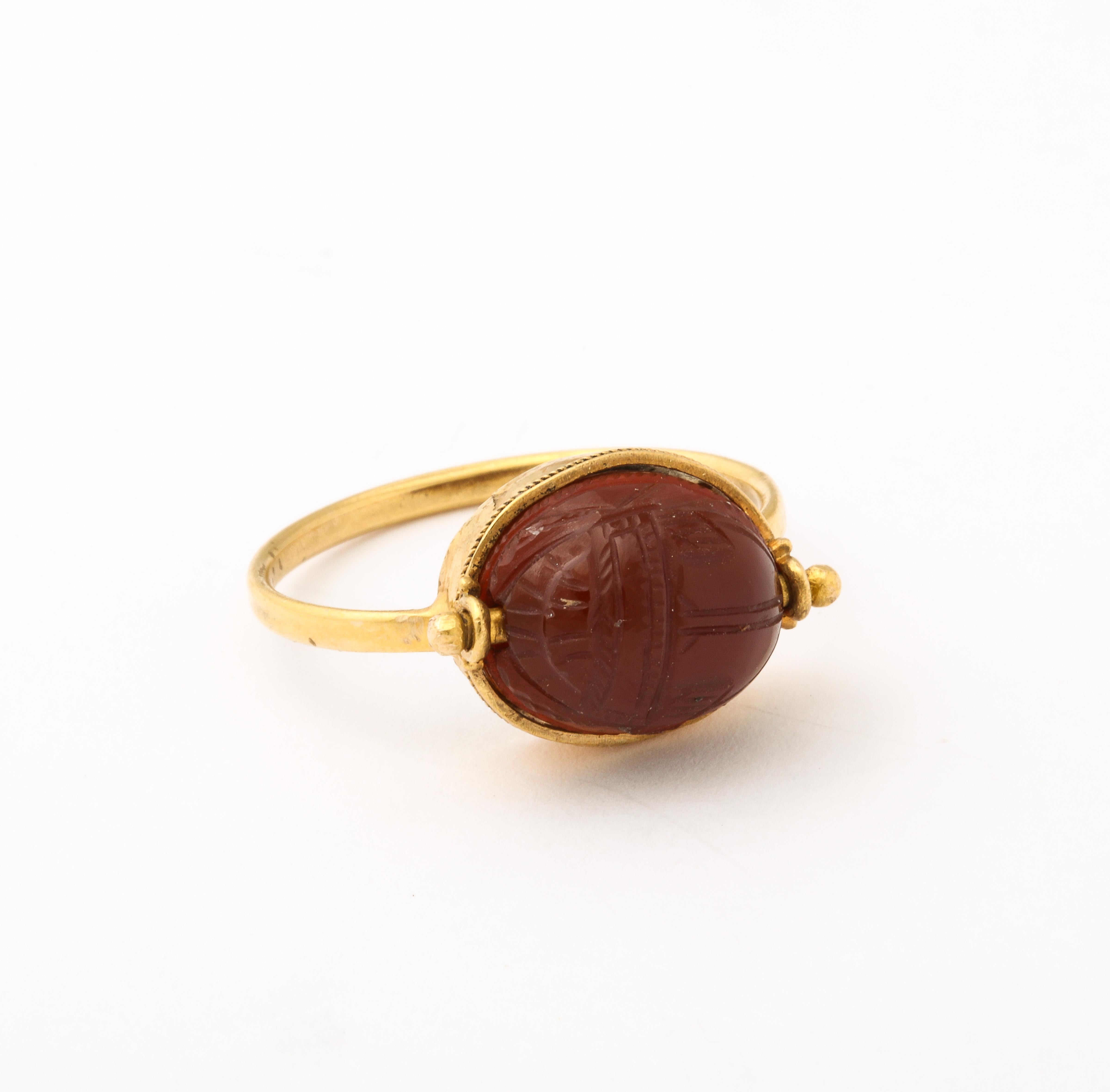 An Egyptian Revival Carnelian Scarab ring, set in 18kt gold is orange brown in color and was created in c. 1880.  I love the fact that the ring rotates and shows a potter creating an urn on the reverse. This fuels my imagination and makes the time