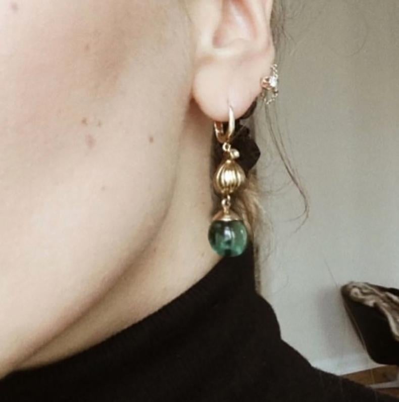These Fig cocktail earrings with cabochon green quartz drops  are in 18 karat rose gold. They were designed by Polya Medvedeva, an artist from Berlin who drew inspiration from the sweet and fresh fragrances of fig to create a jewellery collection.