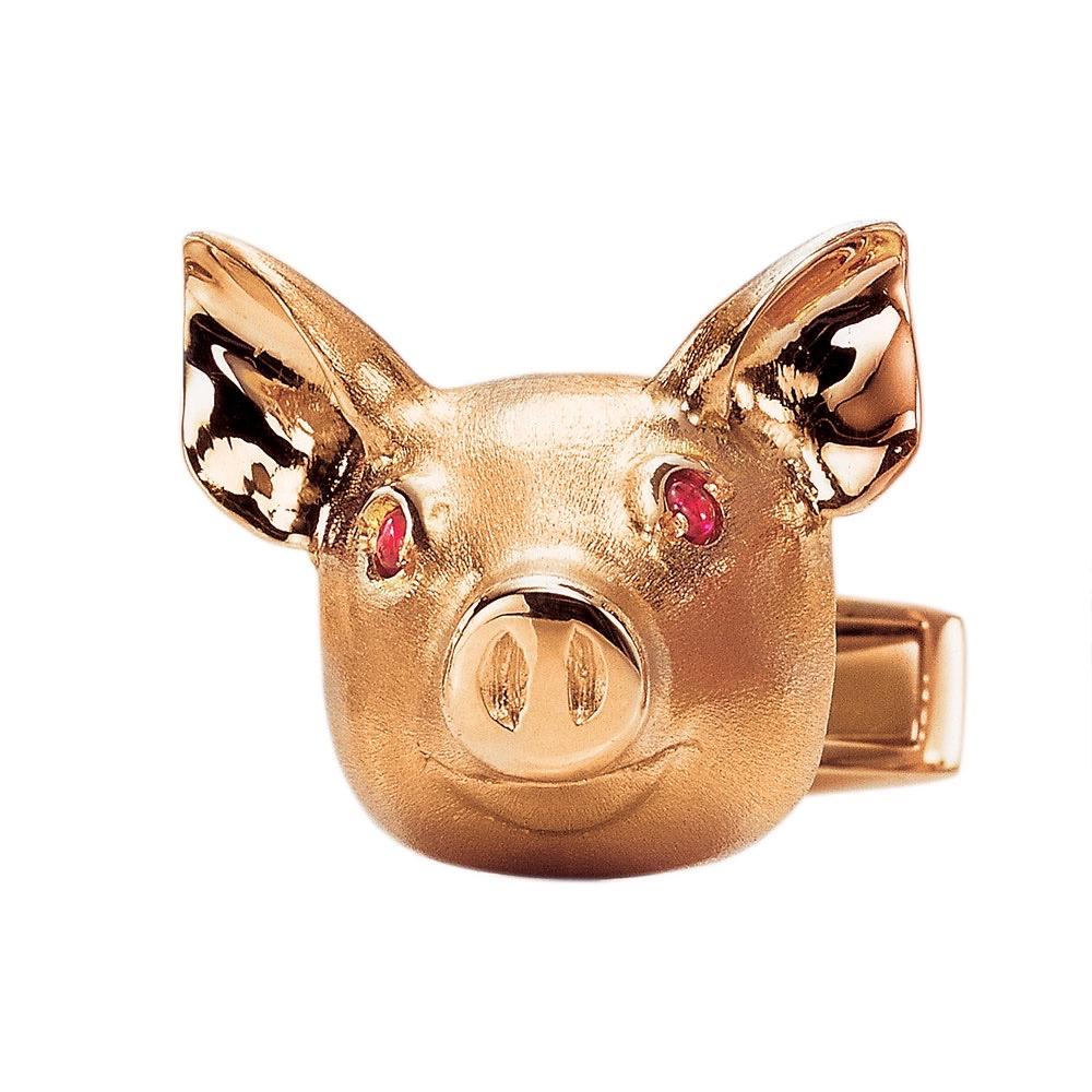 Pig head cufflinks designed in an 18 karat brushed rose gold. The pigs eyes are set with cabochon rubies. They  pigs are approximately 3/4