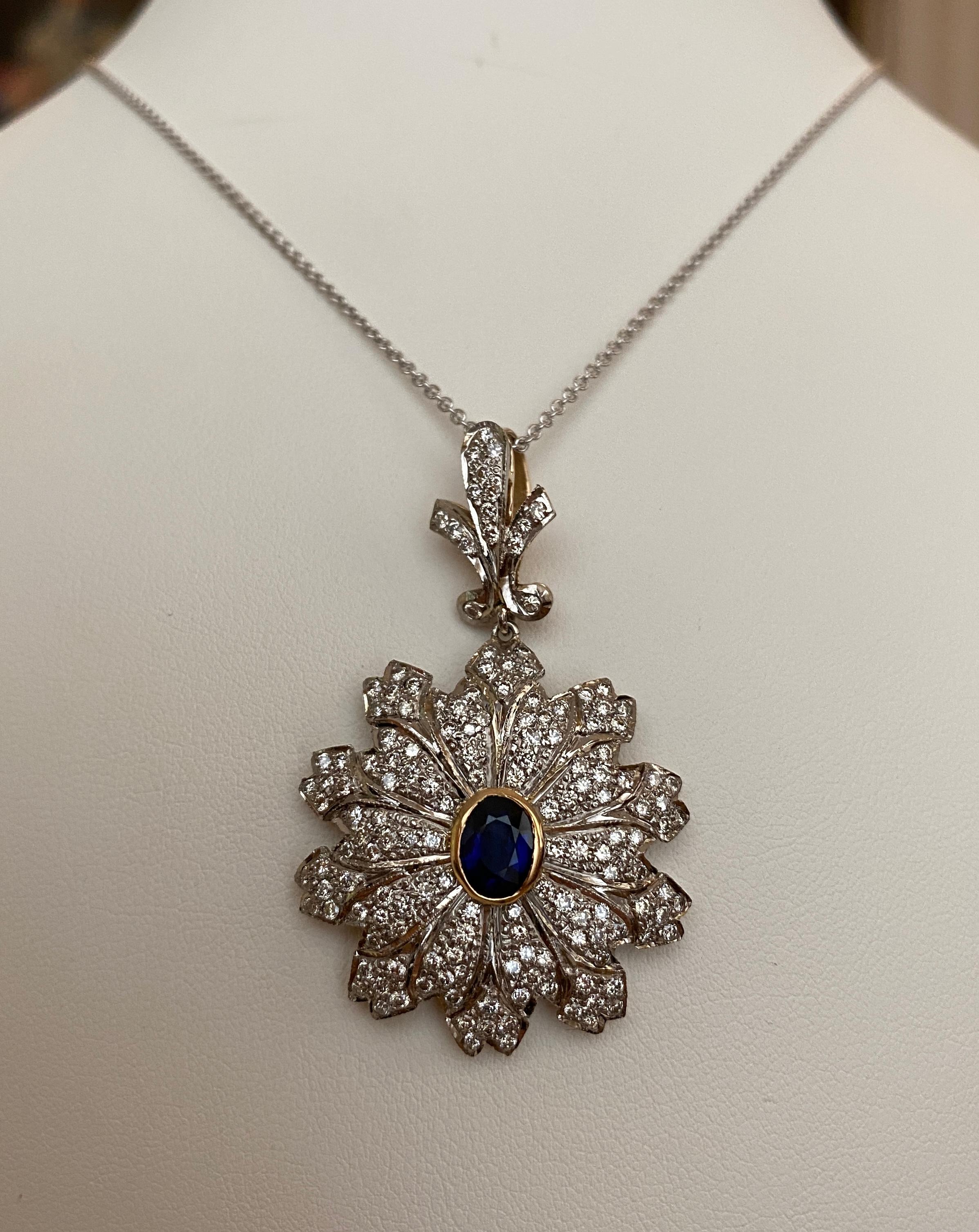 Offered in good condition, beautiful Vintage 18 kt white gold necklace with a pendant made of 18 kt bicolour gold, set with 1 sapphire approx. 1.00 ct and 156 brilliant cut diamonds in total approx. 2.30 ct of quality H/VS/SI.

Necklace as a pendant