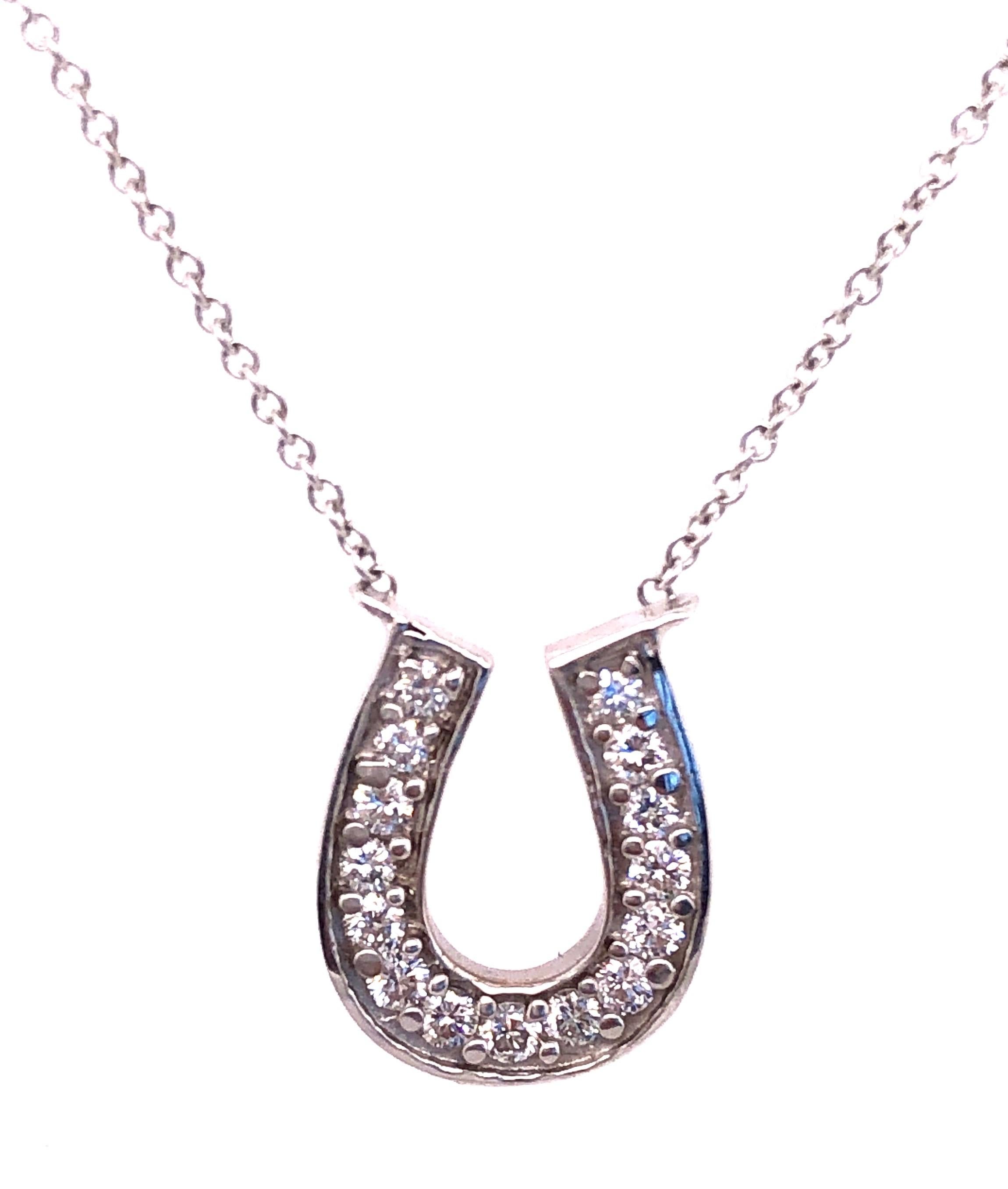 18 Karat White Gold  16 inch Cable Link Necklace with horse shoe soldered Pendant 0.50 Total Diamond weight.
2.70 grams total weight.