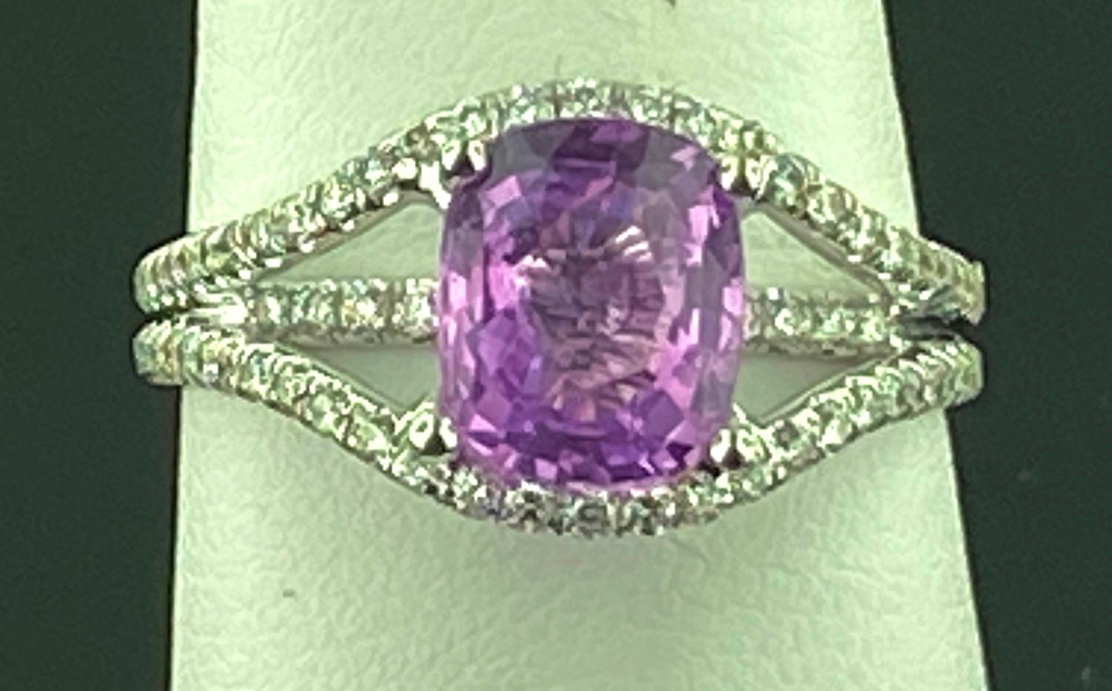 Set in an 18 karat white gold mounting, weighing 4.5 grams, is a 2.37 carat Oval cut Pink Sapphire with 88 round brilliant cut diamonds having a total diamond weight of 0.65 carats.  Color Range of F-G, Clarity of VVS.  Ring size is 8.