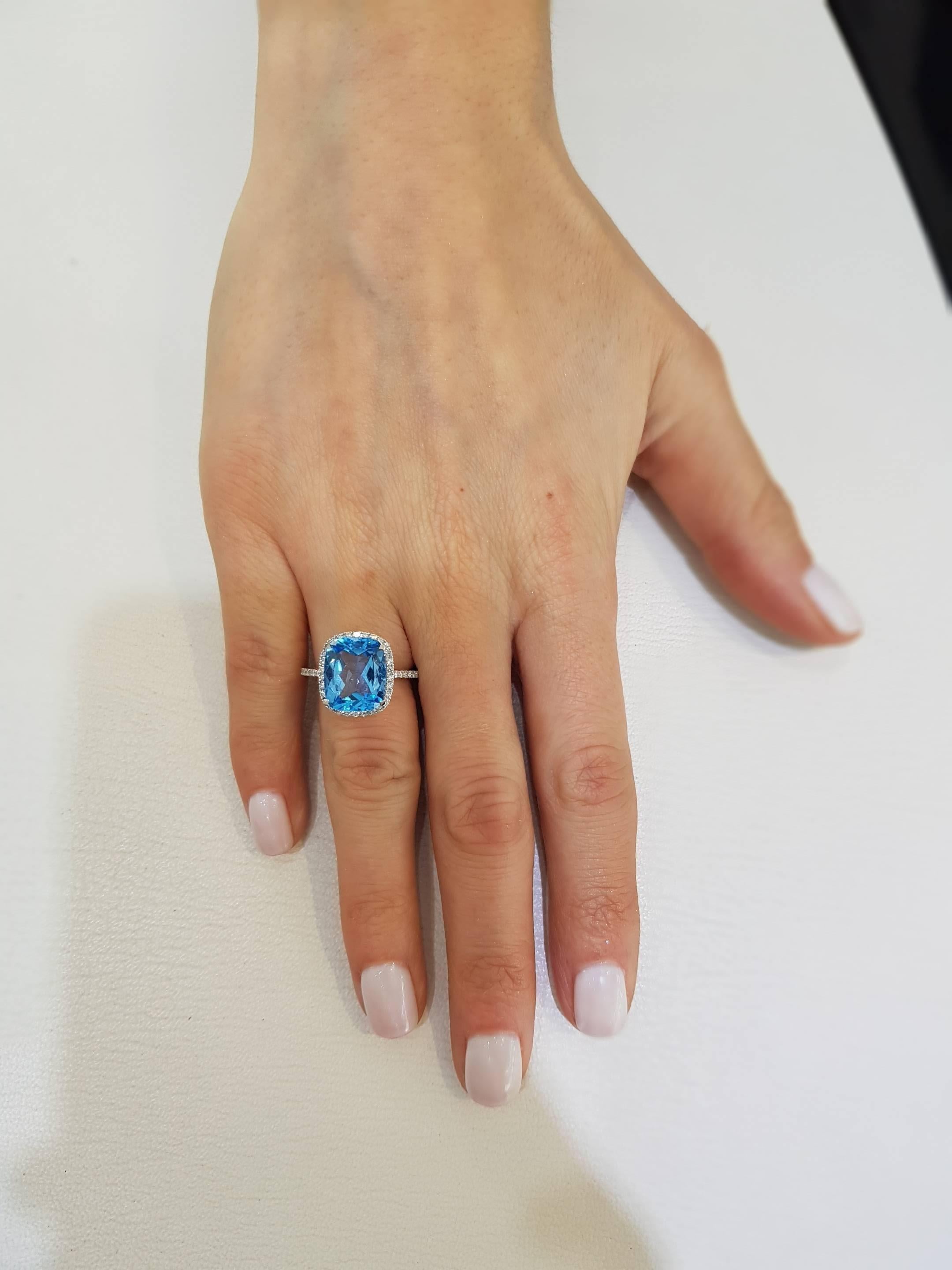 Modern Blue Topaz  6 Carat Cushion Cut 18 Karat White Gold 0.38 Carat Diamond Halo Ring For Sale