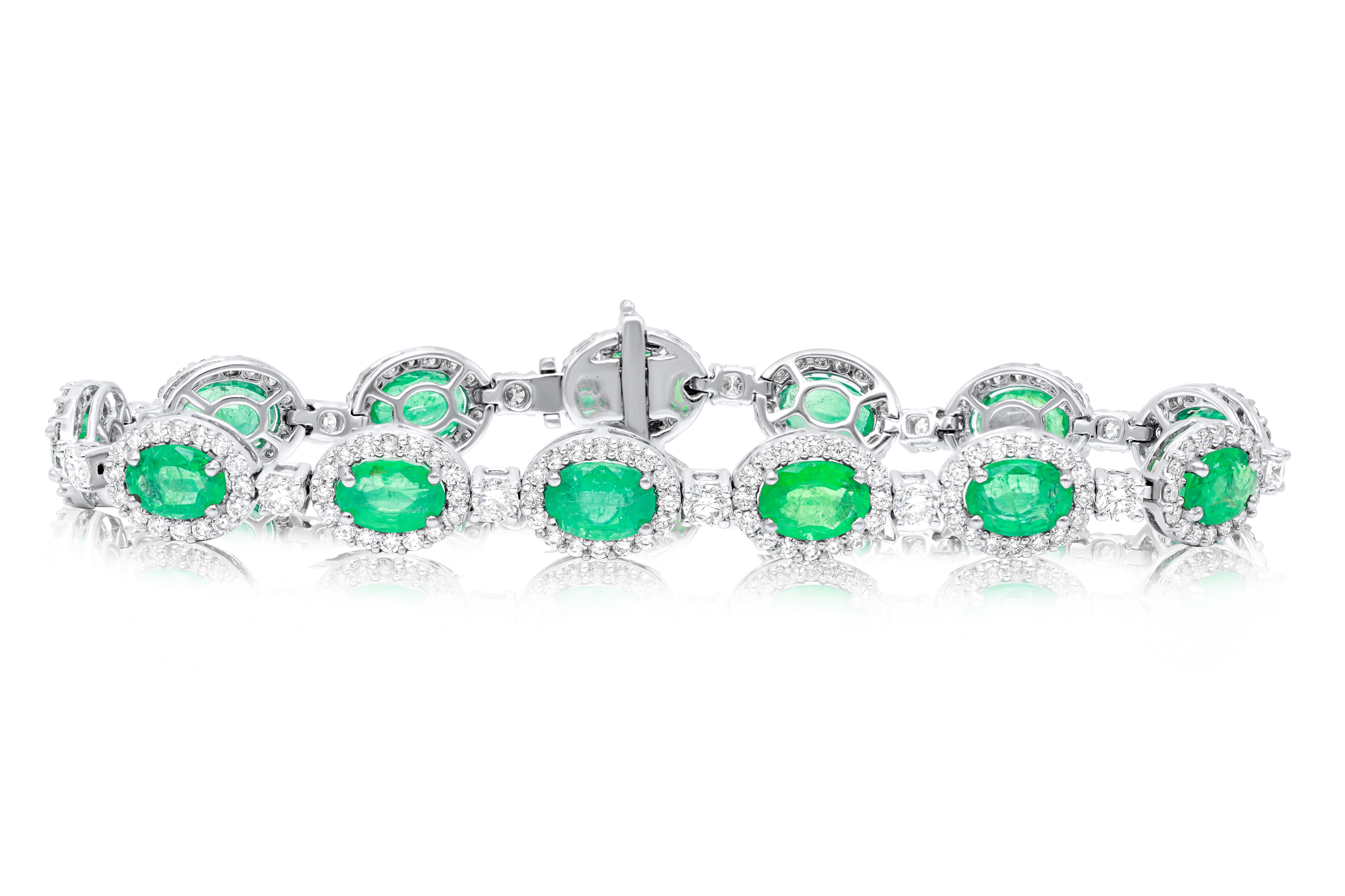 18 kt white gold bracelet adorned with 9.68 cts tw of oval cut green emeralds surrounded and separated by 4.07 cts tw of diamonds