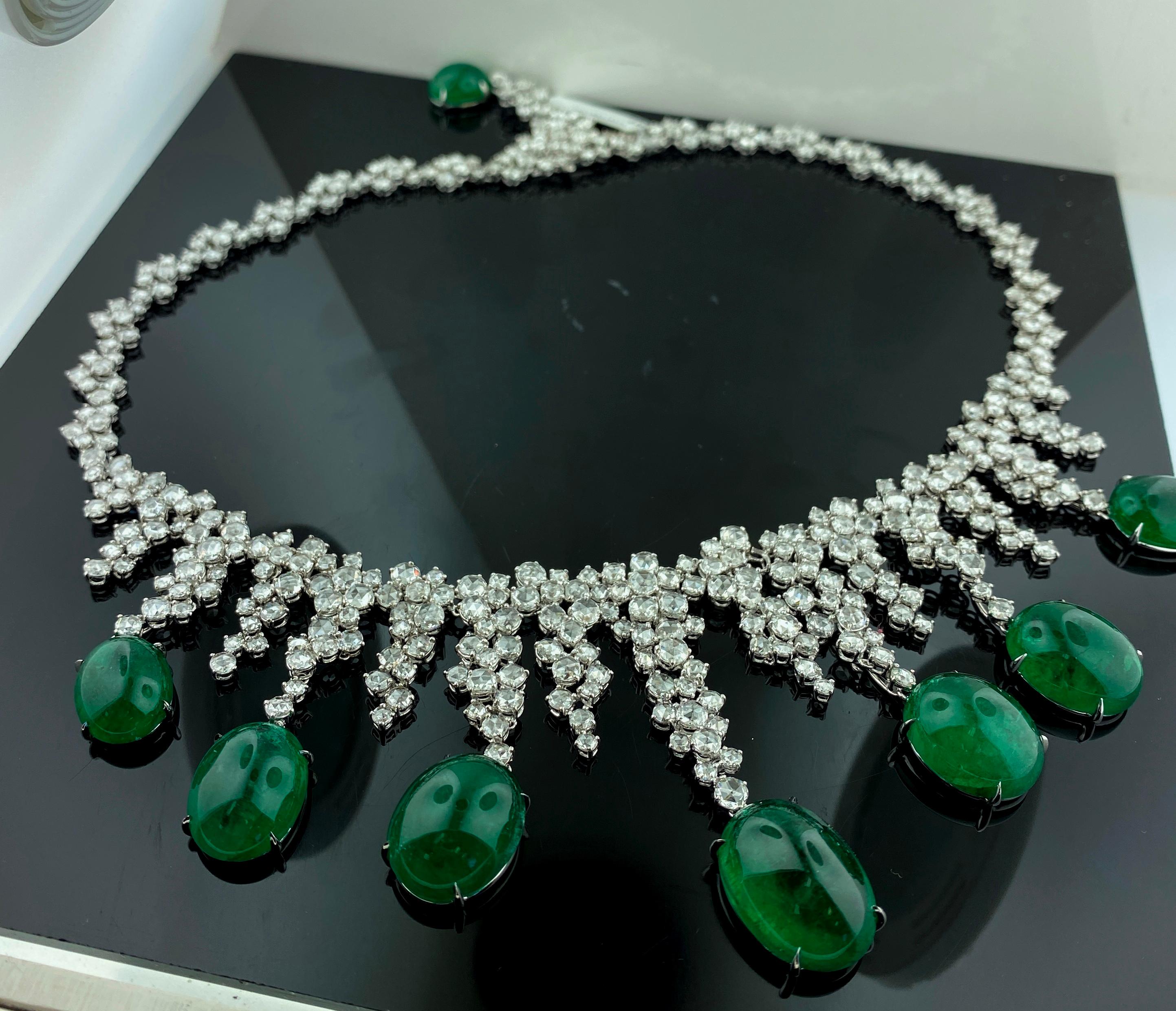 Set in 18 karat white gold are 8 oval shaped Cabochon Emeralds with a total weight of 104.02 carats plus 30.27 carats of round brilliant cut diamonds in an 