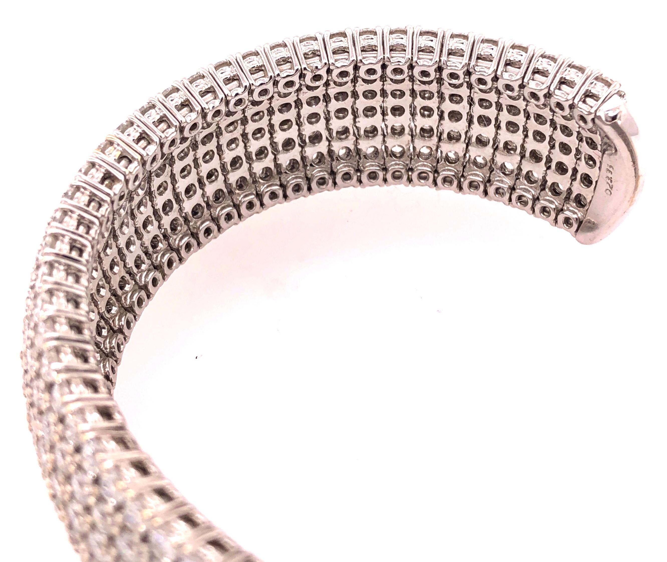18 Kt White Gold & Diamond Cuff Bracelet Weighing Approx 32.89 Ct. This fine quality diamond bracelet of spring band design has a side cuff set entirely with circular cut diamonds totaling almost 33 carats in total. The whole mounted in 18 Kt white