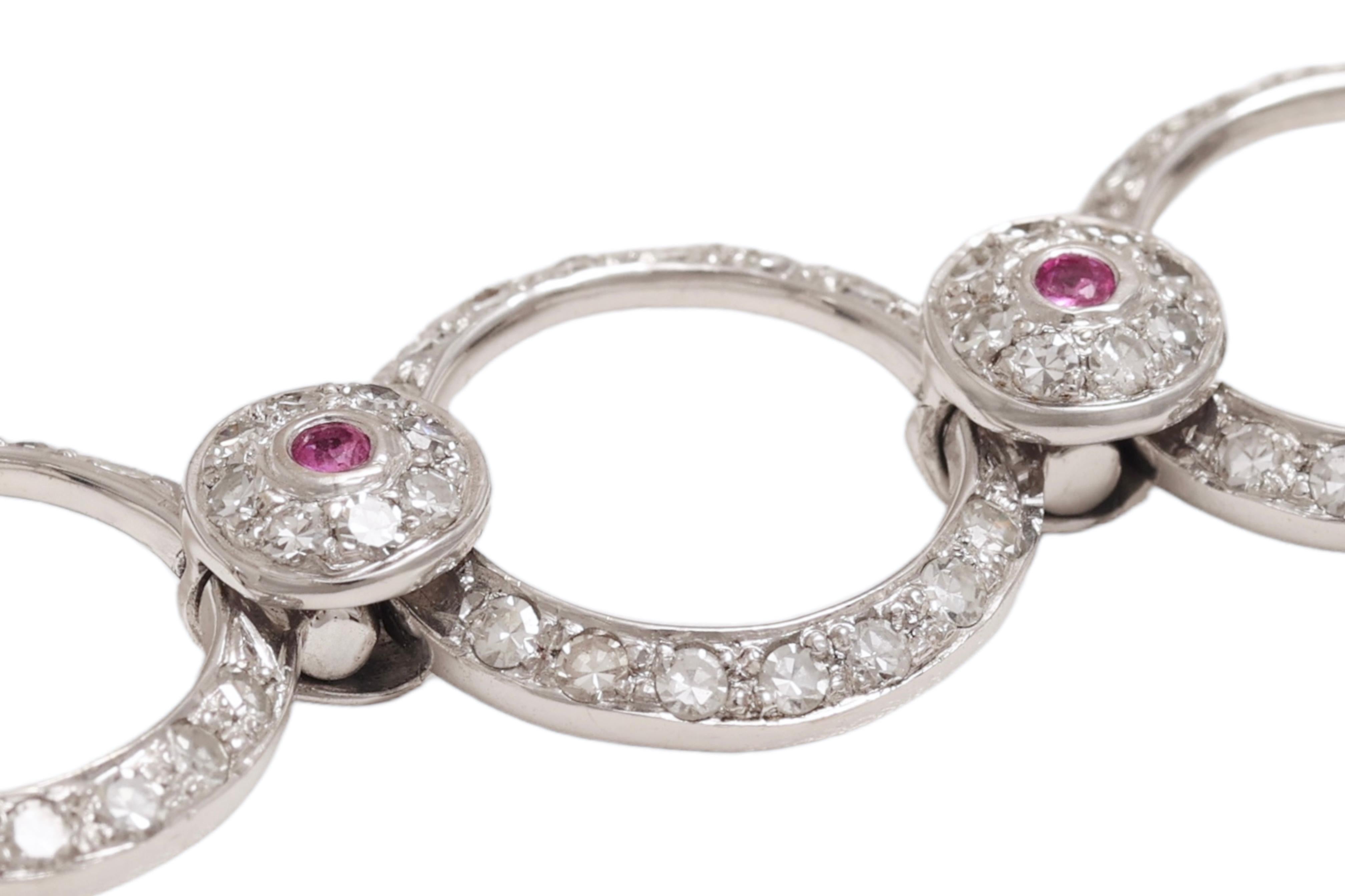 MATERIAL: 18 kt white gold

WEIGHT: 19,9 grams / 0,7 oz / 12.9 dwt

SIZE: to fit wrist 17,5 cm

Diamonds & Pink Sapphires

12 sapphires  0.15 Ct
Diamonds : 3.91 Ct

