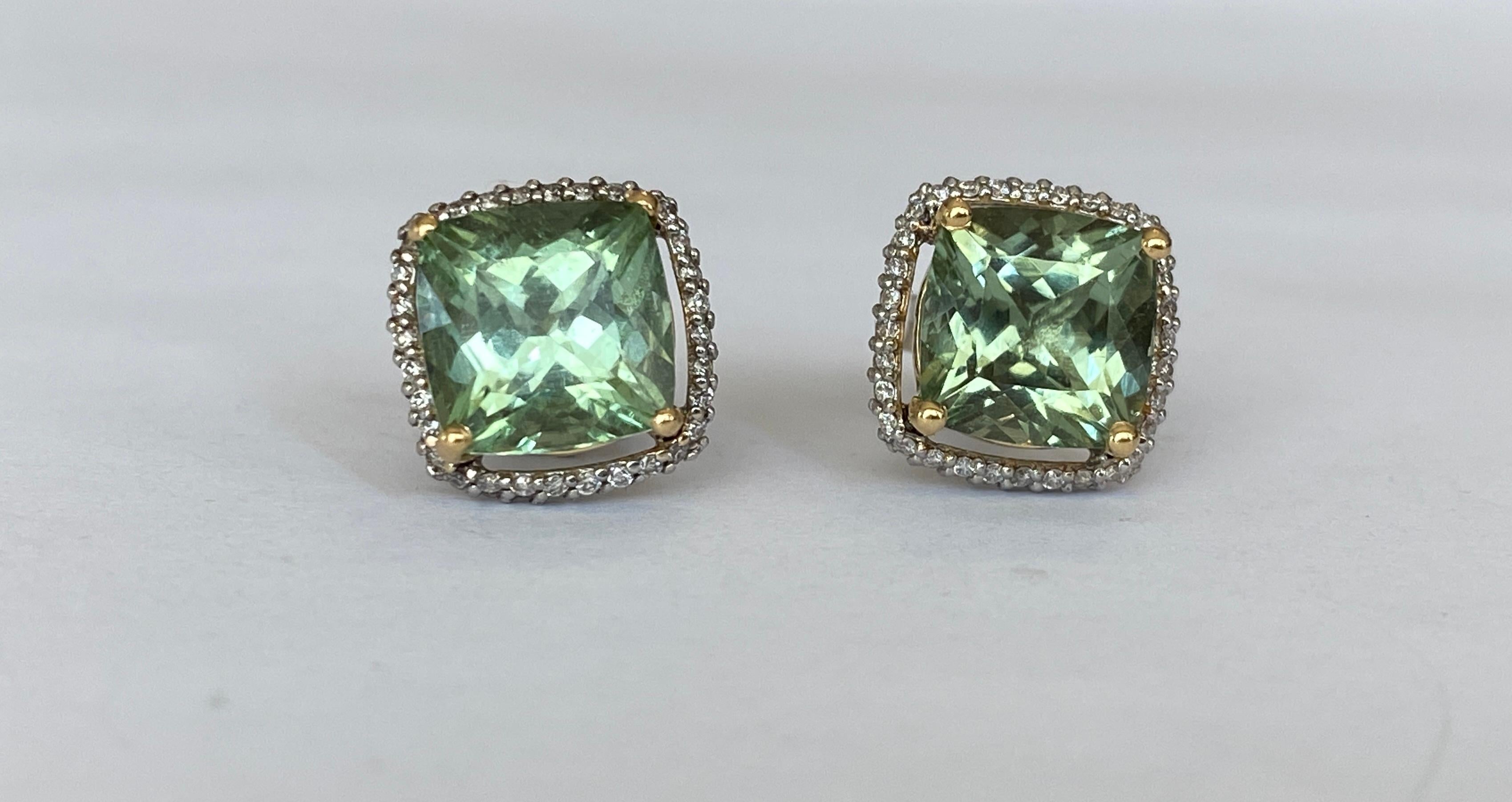 Offered ear studs in white gold and yellow gold details, with two pieces of Cushion  cut Green Tourmaline approx. 5.00 carat together. The stones are surrounded by an entourage of 128 stuks  brilliant cut diamonds, approx. 0.45 ct in total, of