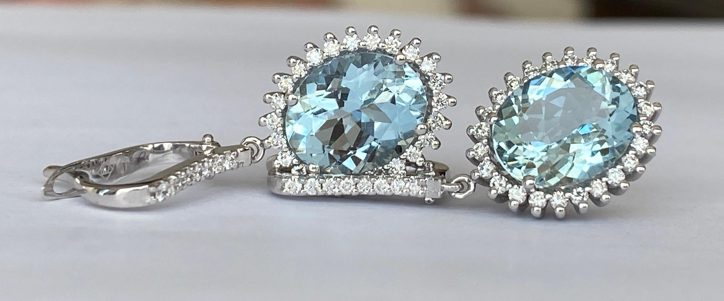 Offered are beautiful ear studs in white gold, with two oval faceted aquamarines of approx. 6.02 carats. The stones are surrounded by an entourage of 64 brilliant cut diamonds in total approx. 0.55 ct of quality F/G/VS/SI. ALGT certificate is
