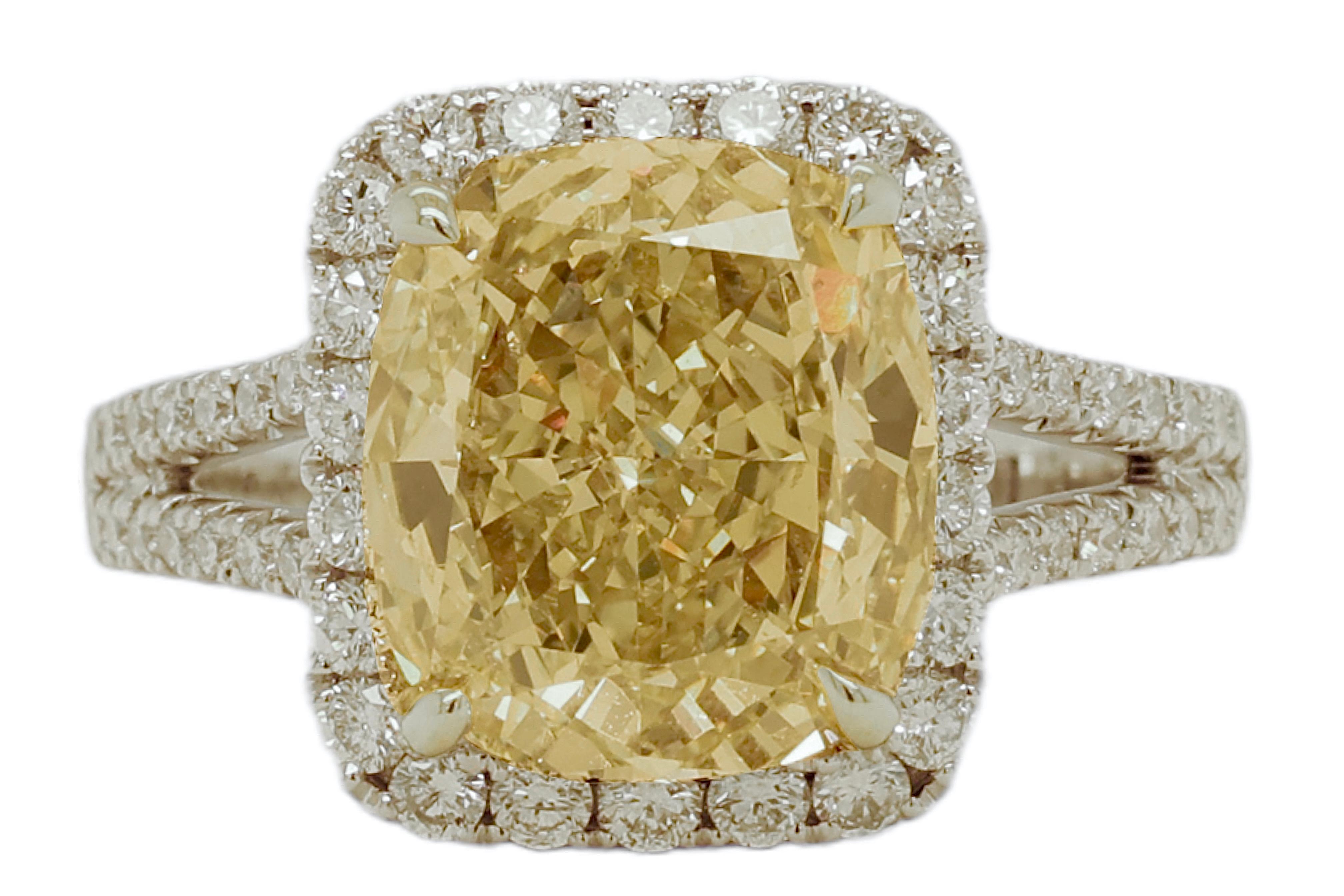 Magnificant 18 kt. White Gold 5.9 Ct Diamonds Engagement Ring With 5 Ct Large Fancy Light Yellow Diamond

Center diamond: 5 Ct Fancy Light Yellow cushion cut Diamond
Surrounding diamonds: brilliant cut diamonds together approx. 0.97 ct. 

Material: