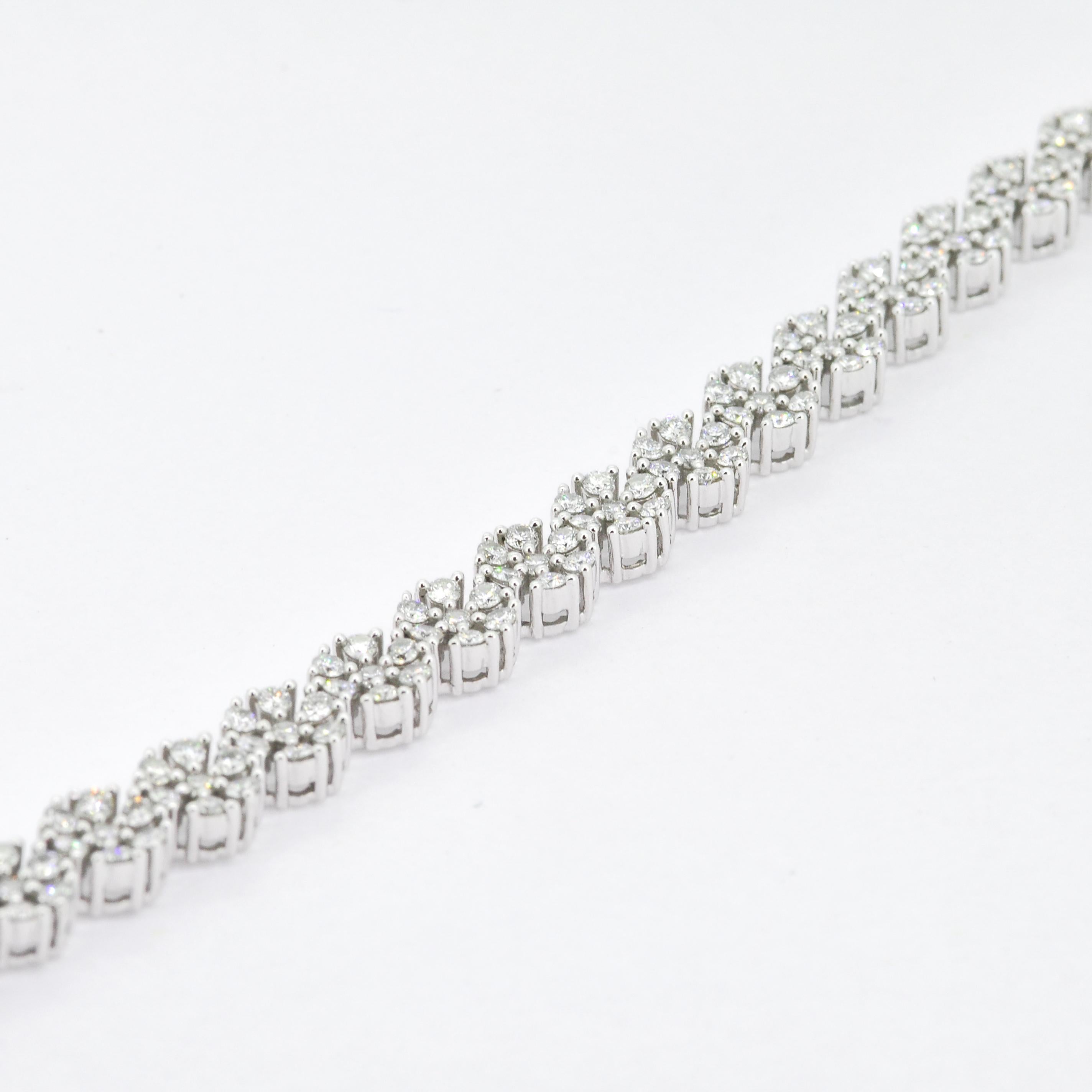 Crafted in 18K white gold, this spectacular diamonds - each artfully set to enhance size and sparkle - to make it each piece look like a flower. Beautifully Handcrafted with such Precision! 

The centerpiece of this bracelet is its flower pattern,