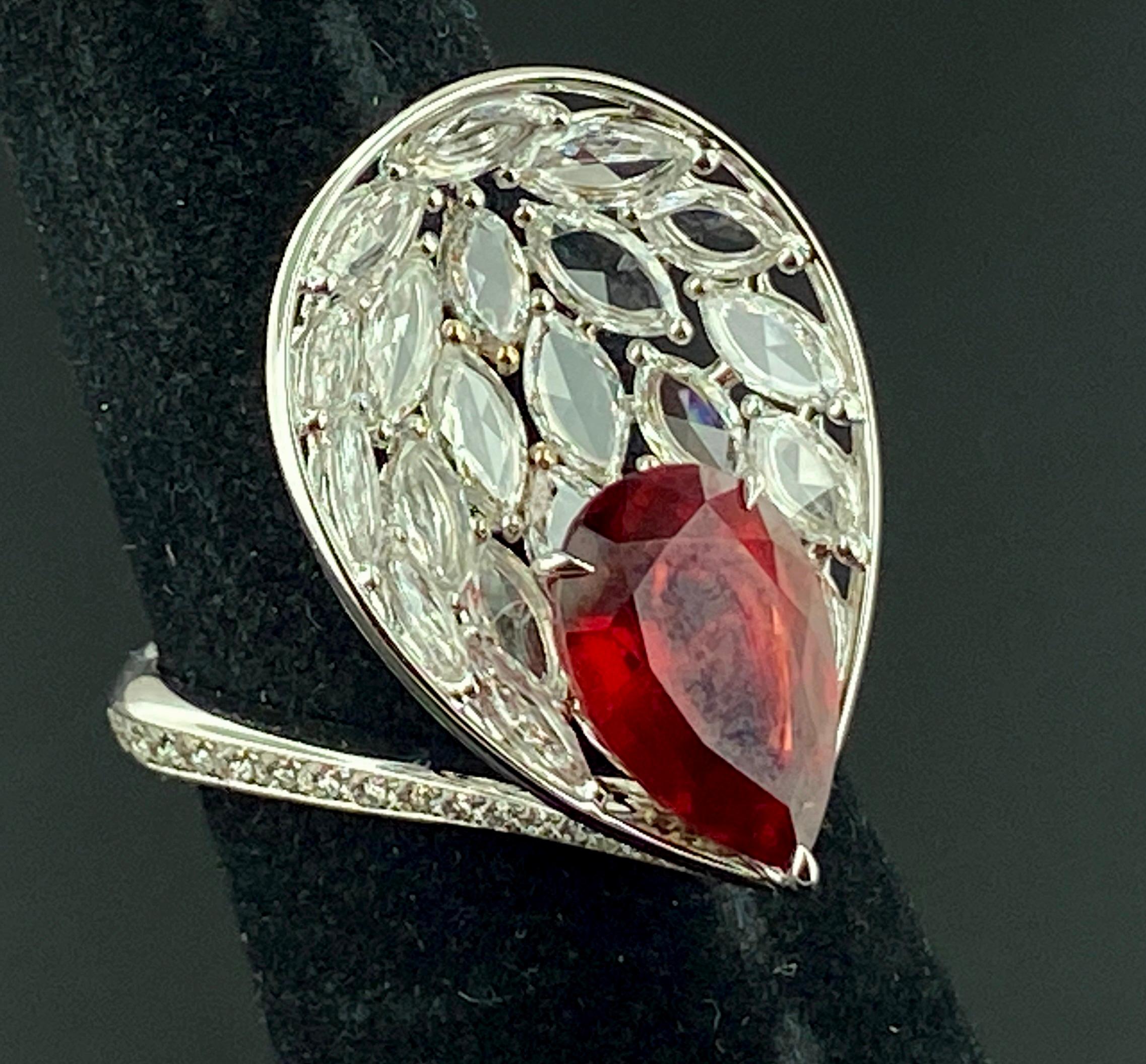 Set in 18 karat white gold is a Pear Shaped Ruby weighing 3.88 carats, along with 21 marquise shaped diamonds weighing 1.86 carats.  Ring size is 6.50.  Gold weight is 6 grams.
