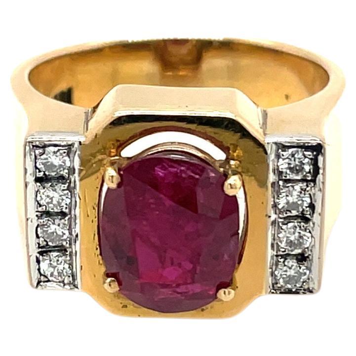 18 karat yellow gold ring set with an oval ruby weighing 2.35 carats.  There are 8 round brilliant diamonds 0.15 carats on either side of the ruby.
Stamped 18k 750
Size 6
