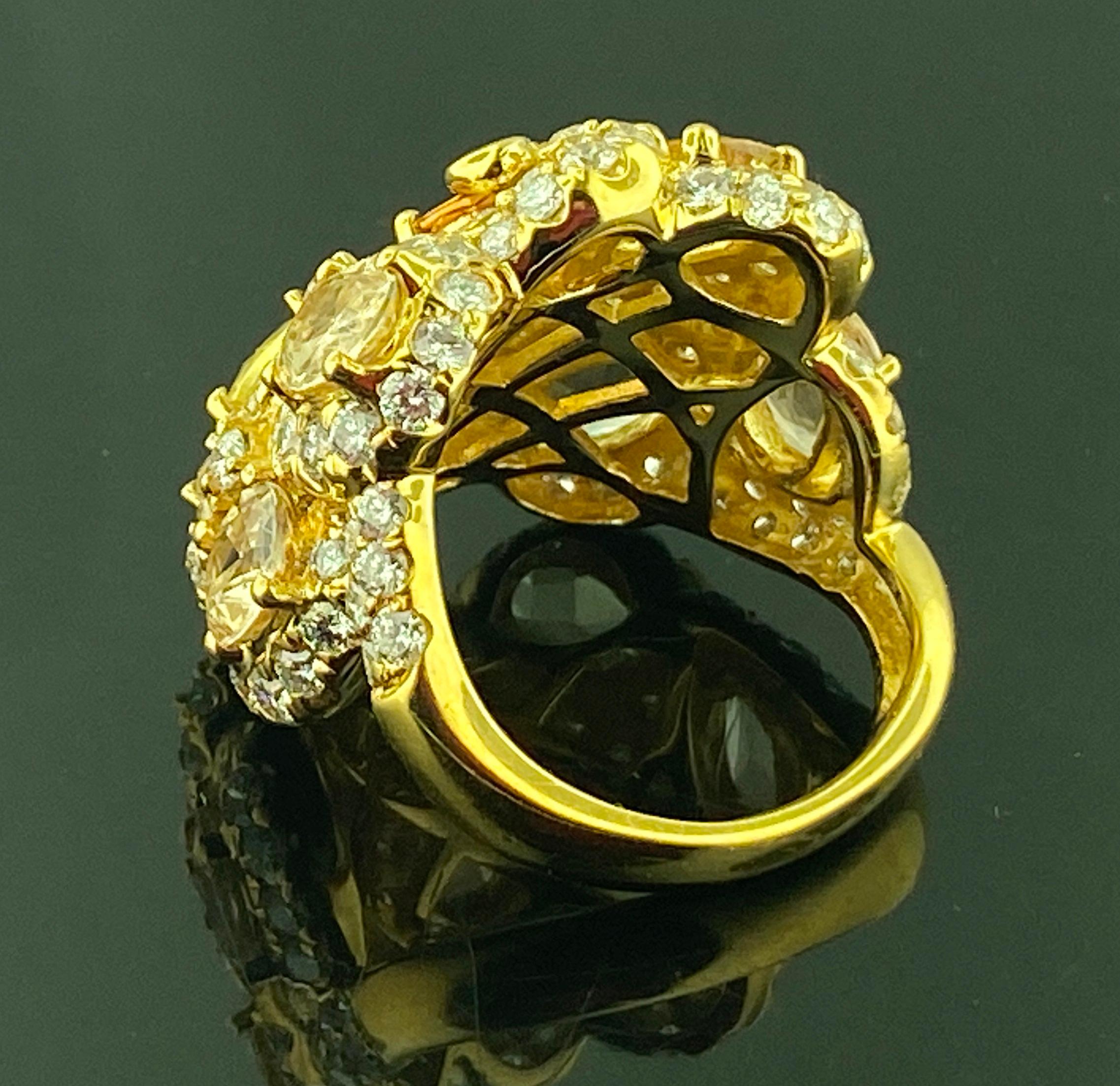 Set in 18 karat yellow gold, weighing 15.63 grams, are 7 Oval Sapphires - 6 Yellow and One Orangey Brown - weighing a total of 8.75 carats accented with 100 Round Brilliant Cut diamonds weighing a total of 3.00 carats having a Color Range of: F-G,