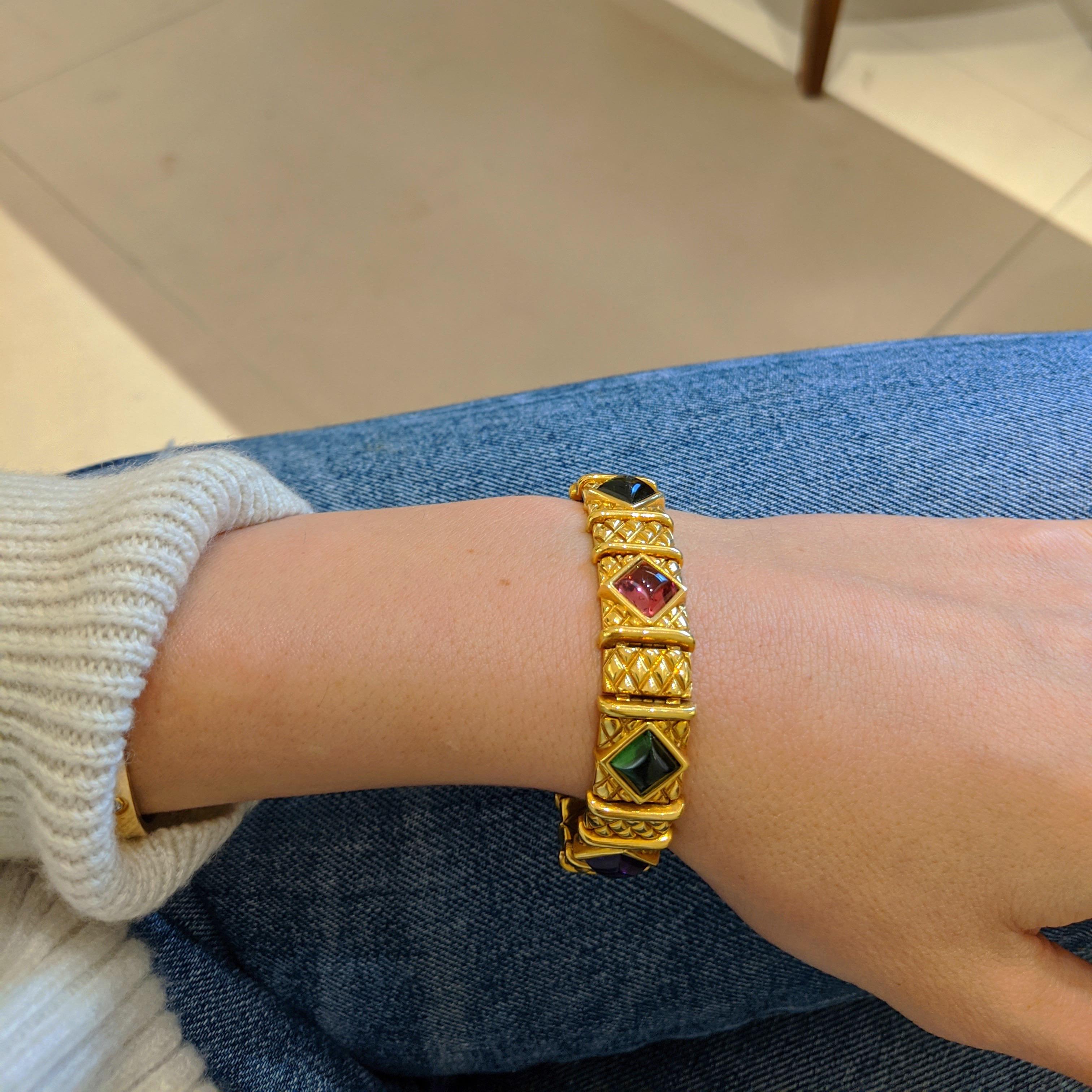 This bracelet is designed with 15 yellow gold links each with a quilted diamond pattern. Every other link features diamond shaped cabachon stones of Amethyst, Citrine, Green & Pink Tourmaline that have been bezel set. the bracelet measures 6 1/2