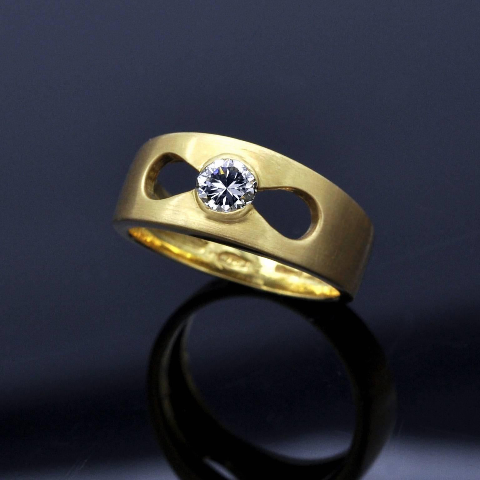 Stylish modern solitaire ring : it is a 18 Karat brushed yellow gold band ring with polished sides showcasing  a 0.35 carat diamond (F G VS2)  in a gracefully designed opening . 
Weight : 6.65 grams