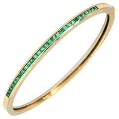 Pulsera brazalete con bisagra de oro amarillo de 18 kt y esmeralda cuadrada