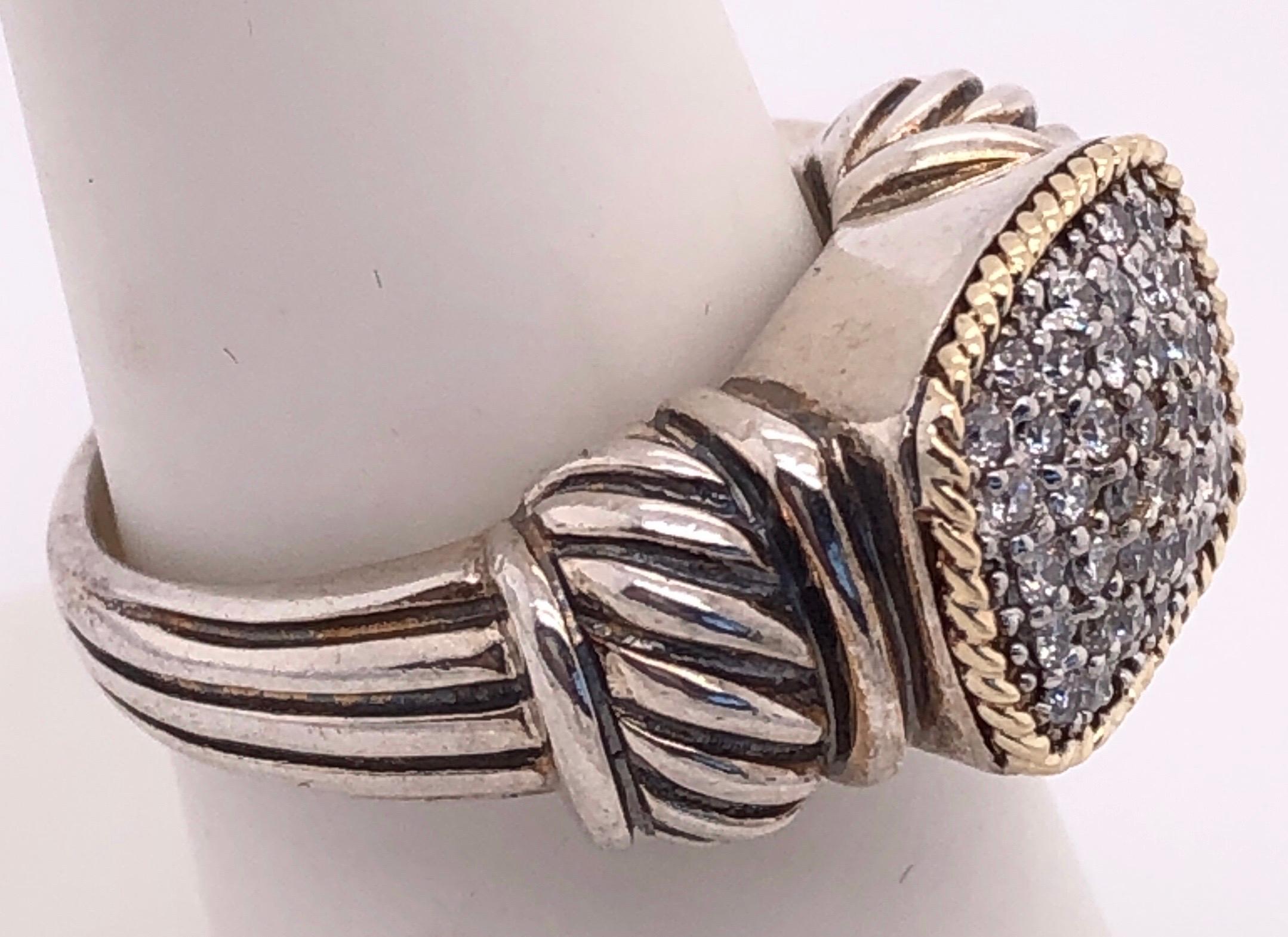 18 Kt Yellow Gold And Sterling Silver With Diamond Cluster Center Ring Size 7.25
1.00 total diamond weight.
8 grams total weight.
Stamped 925 and 18 Karat  
