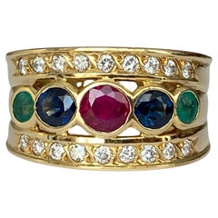 18 Kt. Yellow Gold Band Ring with 0.90 Ct Ruby, Sapphire, Emerald  and Diamonds