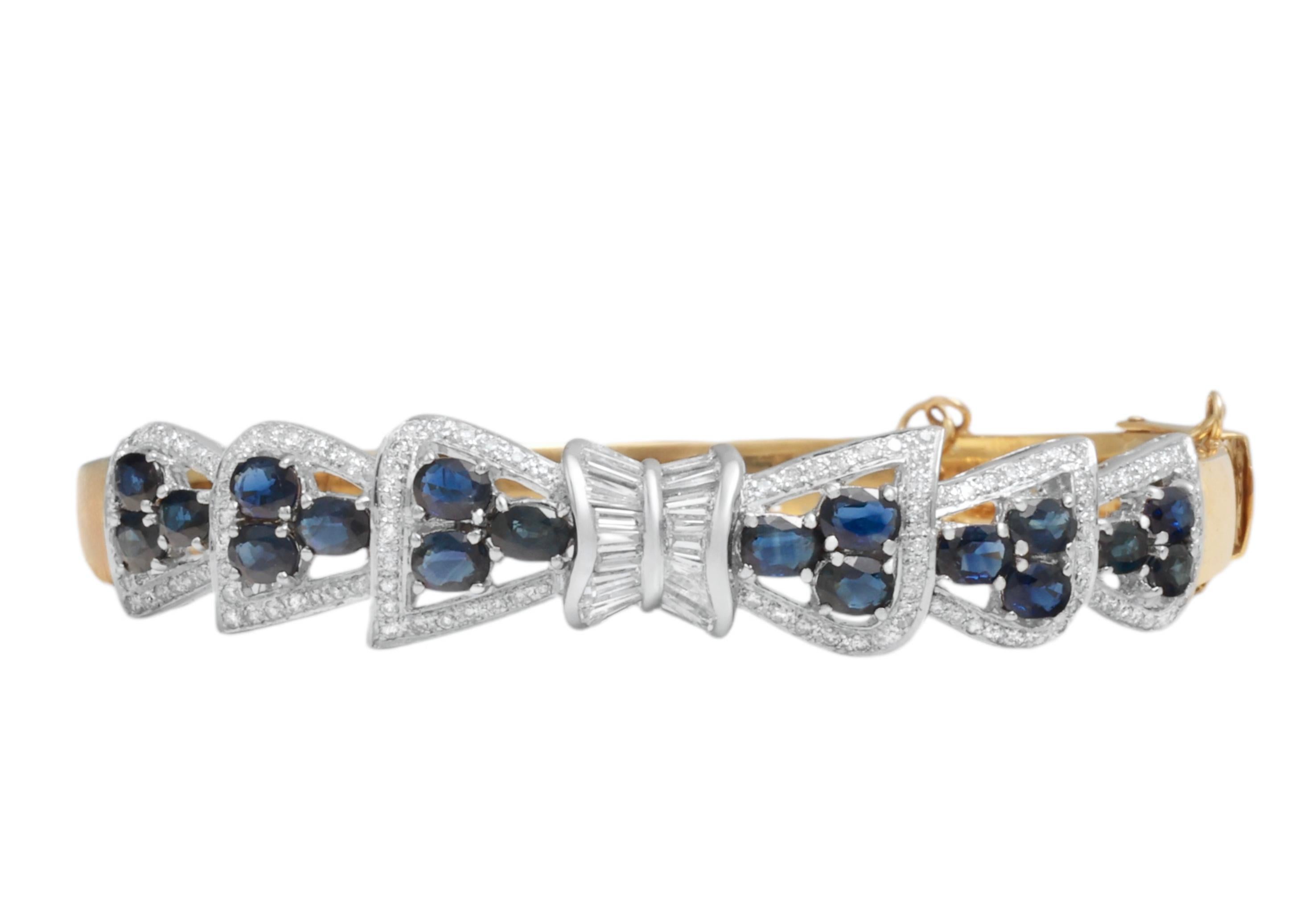 Gorgeous & Classy 18 kt. Yellow Gold Bangle Bracelet With Diamonds and Sapphires 

Diamonds: Brilliant & baguette cut diamonds, together approx. 2 ct.

Sapphires: Together approx. 2.7 ct.

Material: 18 kt. yellow & white gold

Measurements: Will fit