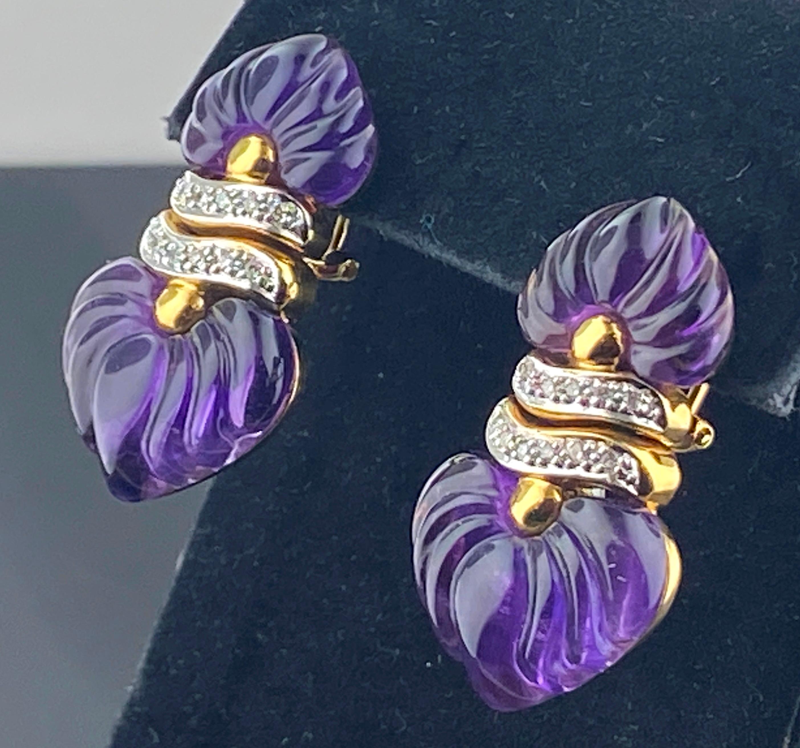 Set in 18 karat yellow gold are 4 pieces of carved Amethyst with 22 Round Brilliant Cut Diamonds with a total weight of 0.18 carats.