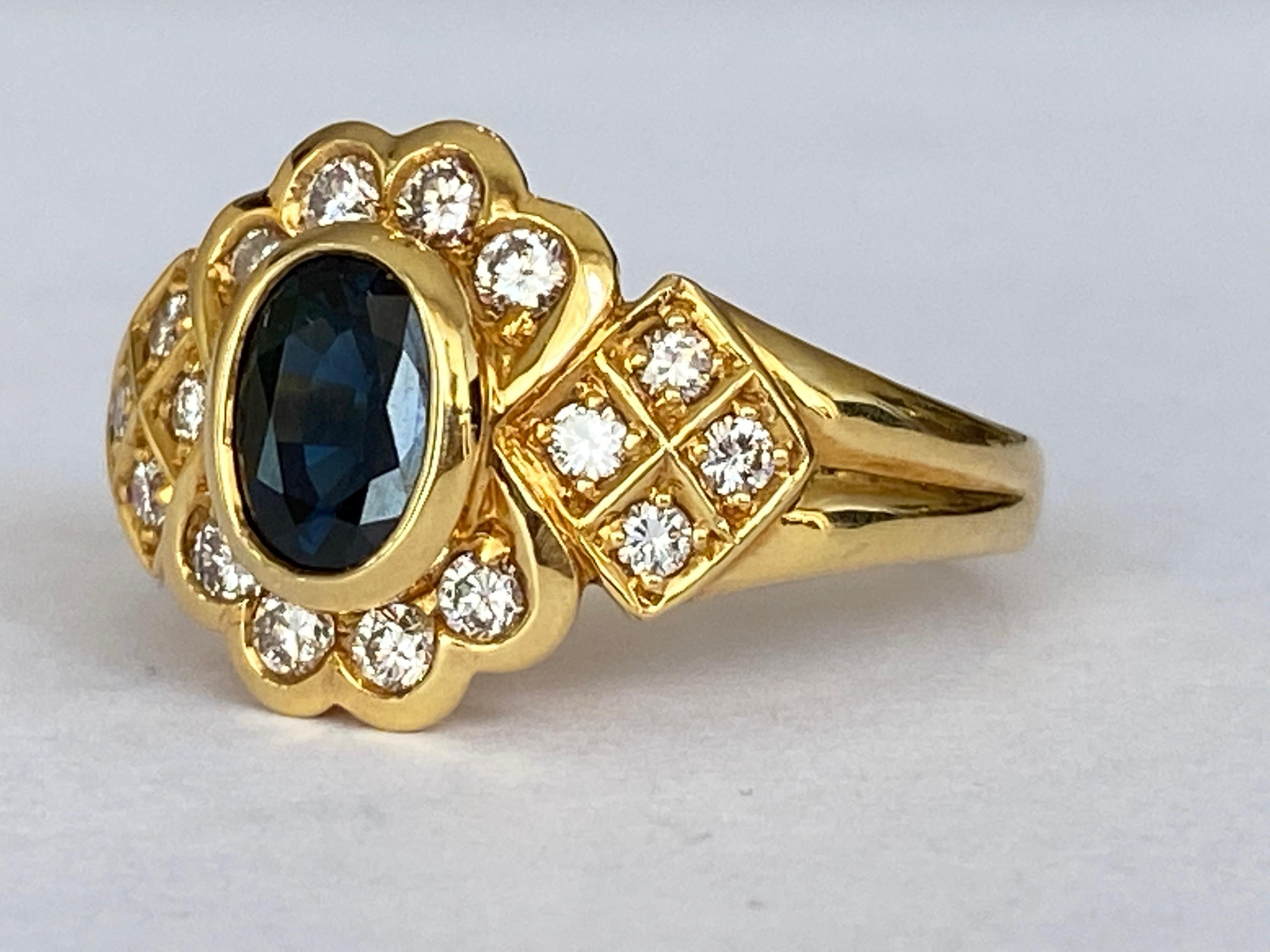On offer is an 18 carat yellow gold entourage ring decorated in the center with 1 piece of oval cut natural sapphire of approx. 1.00 ct and with 16  brilliant cut diamonds of approx. 0.46 ct in total, of quality G/VS.
Gold content: 750 (hallmarked)