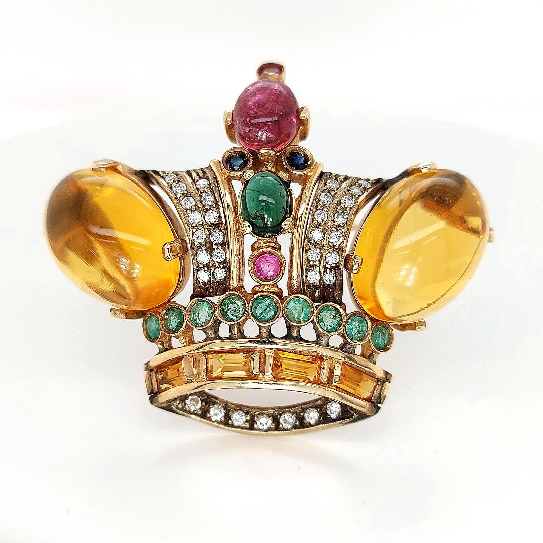 18 kt Yellow gold Crown Brooch / Pendant with Precious Stones 

Beautiful 18 kt gold crown Brooch/Pendant set with brilliant cut diamonds, emeralds, sapphires, rubies and Huge citrine cabochons

A real eyecatcher handcrafted by our master artist