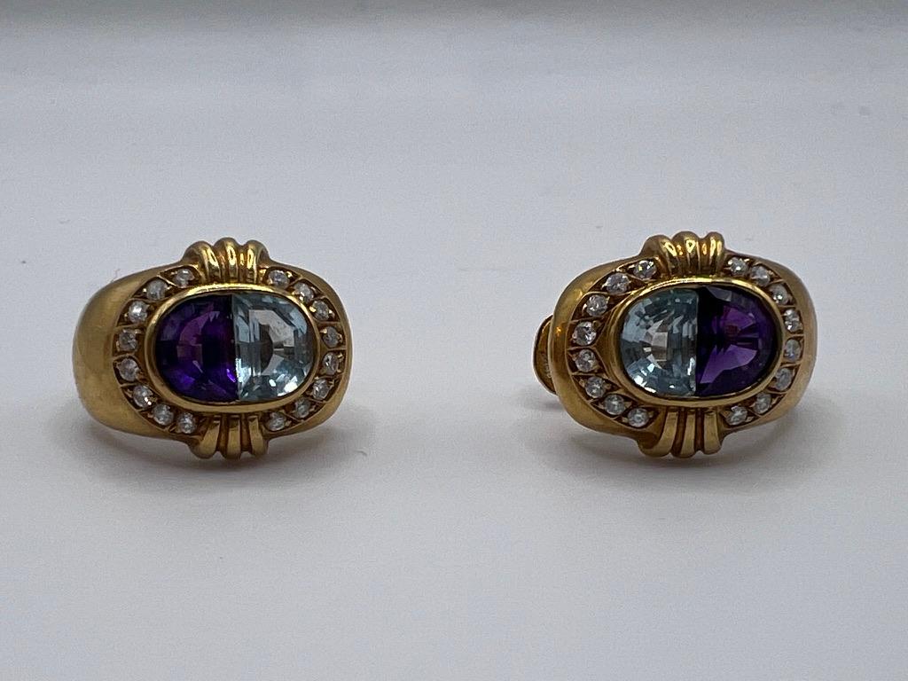 18-kt Yellow Gold Earrings featuring approximately .74 carats of sparkling diamonds, accented by vibrant amethyst and aquamarine gemstones.