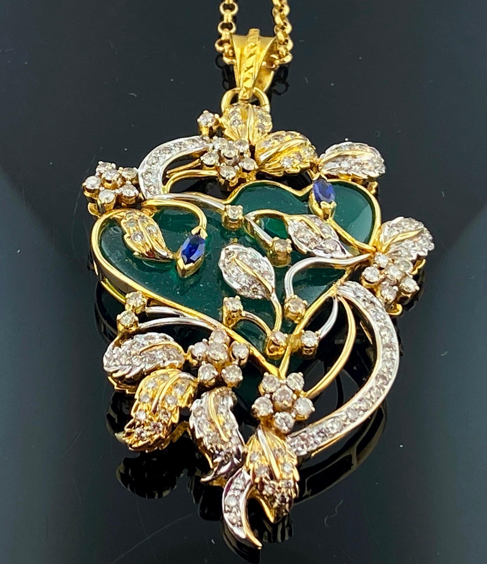 Set in 18 karat yellow gold, weighing 16 grams, are numerous small Round Brilliant Cut diamonds in leaf and flower designs weighing 1.50 carats, enhanced with Green Onyx plus two small Marquise cut Blue Sapphires, on an 18