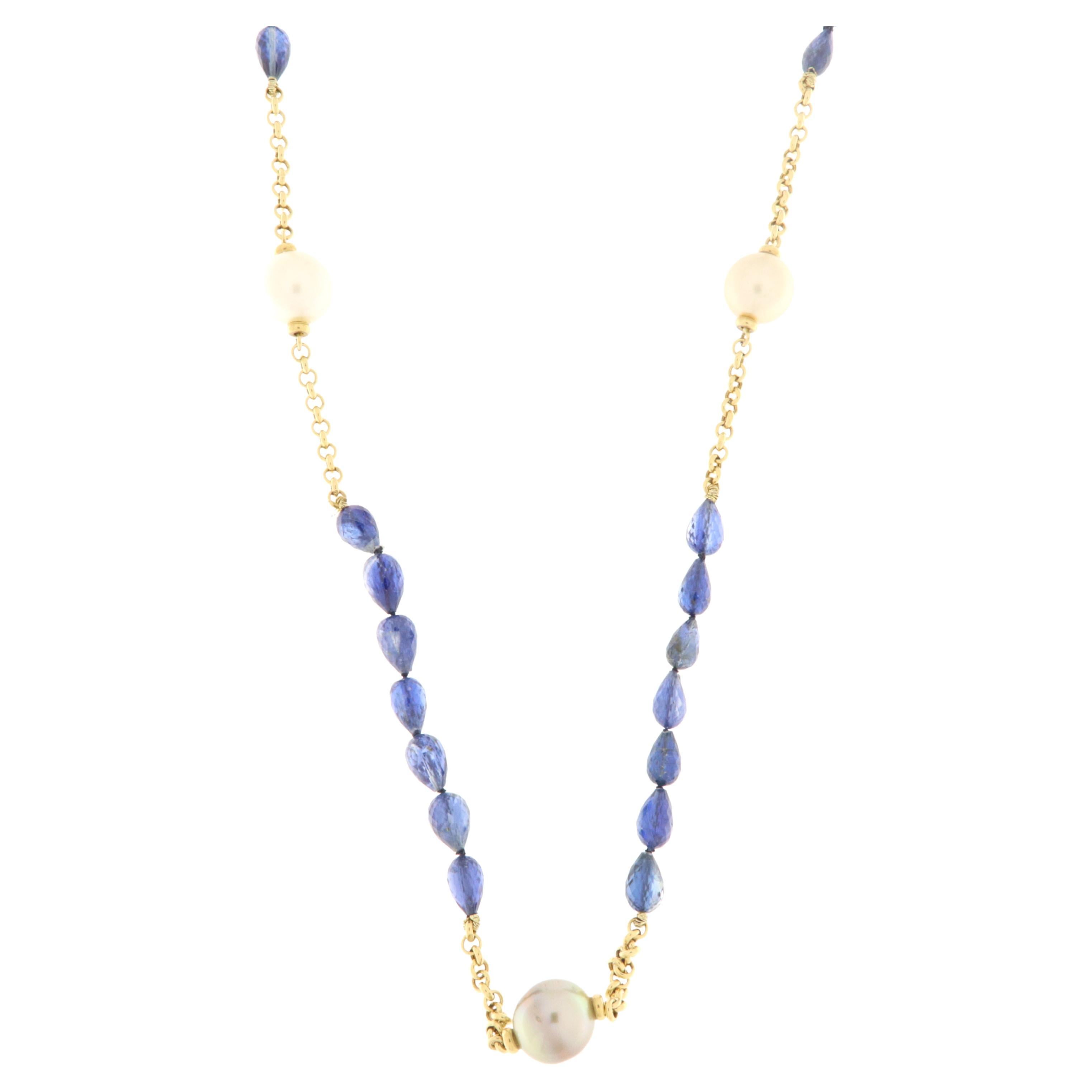 Yellow gold necklace 80 cm long. It alternates gold chain with faceted drop cut kyanite elements and grey, white and gold Australian pearls. Very trendy in the combination of colors and easy to wear, both in the sporty and elegant version.