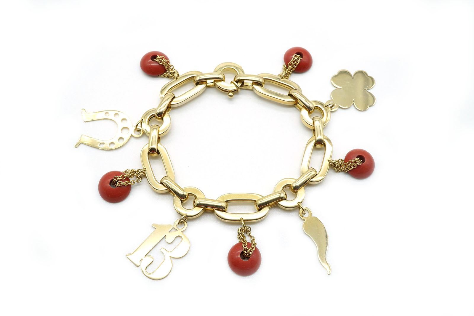 This cute and funny bracelet is made in 18 Kt yellow gold weighing in total gr. 30.00
Links are oval and round and the lobster clasp is very easy to handle.
This bracelet is embellished with four lucky charms and coral paste round charms.
Length is