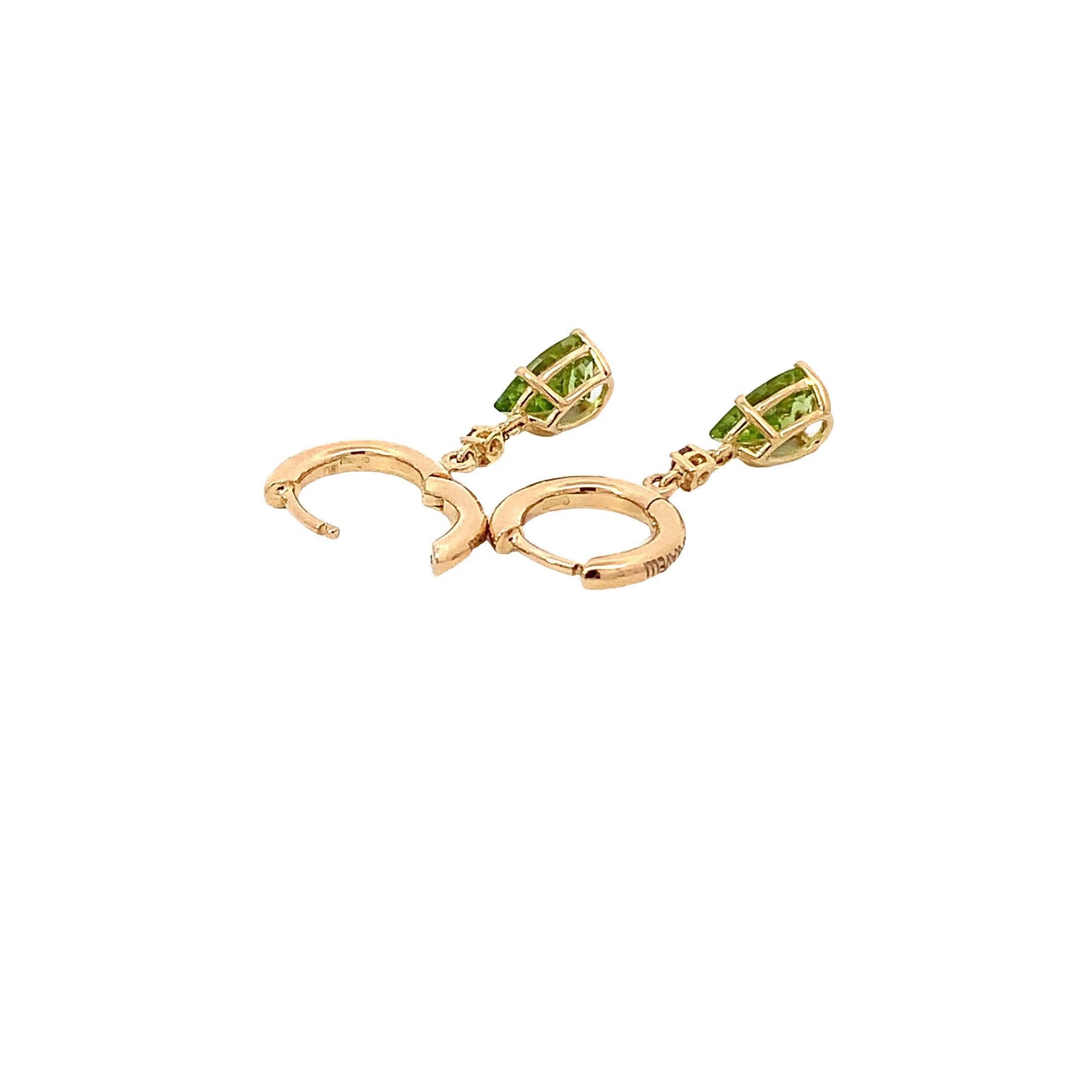 Elevate your elegance with the 18 Karat Yellow Gold Peridot drops  and  brown diamonds Garavelli Hanging Earrings. These exquisite earrings, crafted with precision and style, are a testament to beauty and sophistication.
Each earring is a