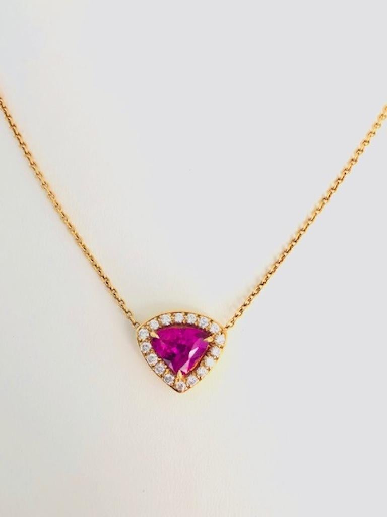 Vivid Pink Sapphire 2.12 carats surrounded by 17 round Diamonds 0.36 carats, in this beautiful 18 Kt Yellow Gold Necklace.

We design and manufacture all our jewelry in our workshop, located in New York City's diamond district.
