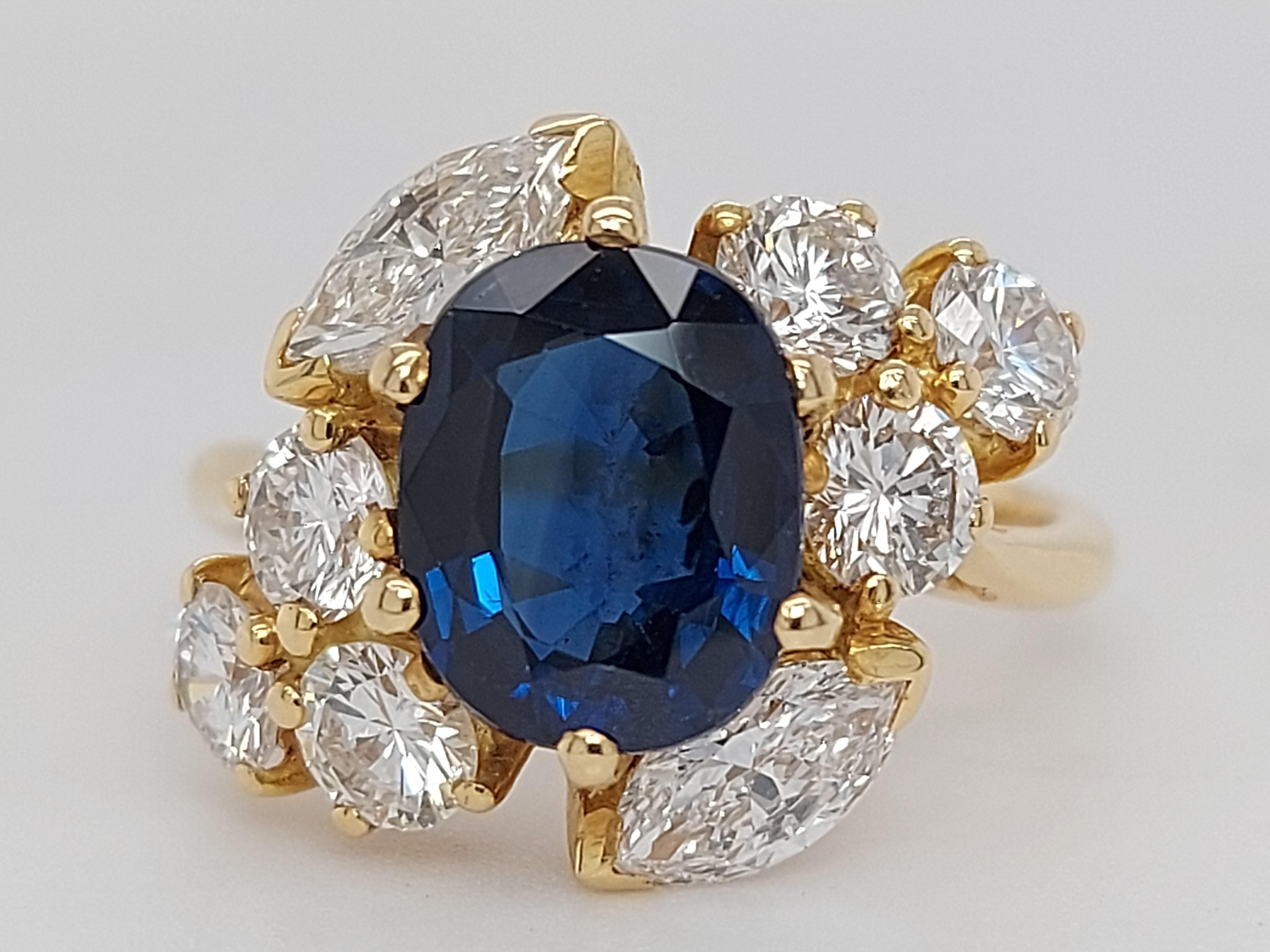 18 Karat Yellow Gold Ring with Oval Sapphire, Marquise and Round Cut Diamonds 2