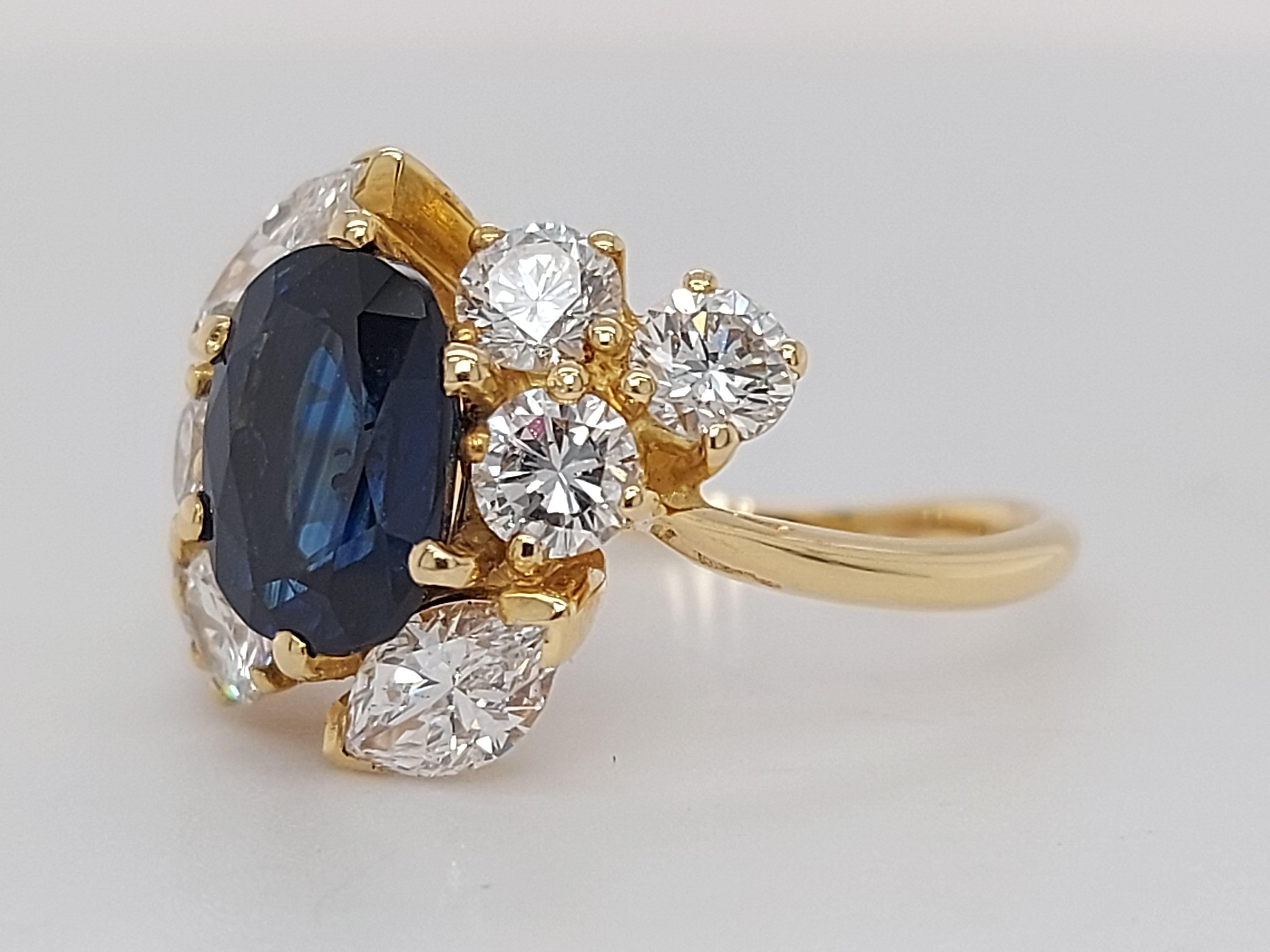 18 Karat Yellow Gold Ring with Oval Sapphire, Marquise and Round Cut Diamonds 3