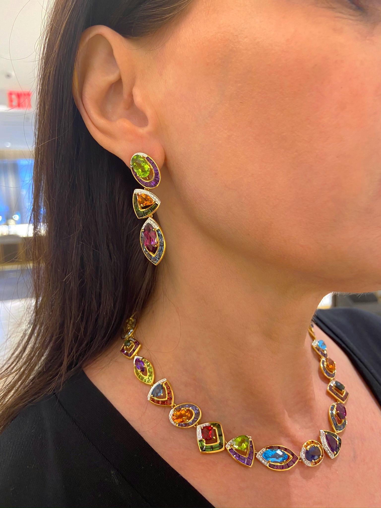 These beautiful crafted 18 karat yellow gold earring are set with an array of Semi Precious stones making them very wearable . The stones include Peridot, Citrine, Garnet, BlueTopaz, Green Tourmaline & Amethyst. Each section is accented with