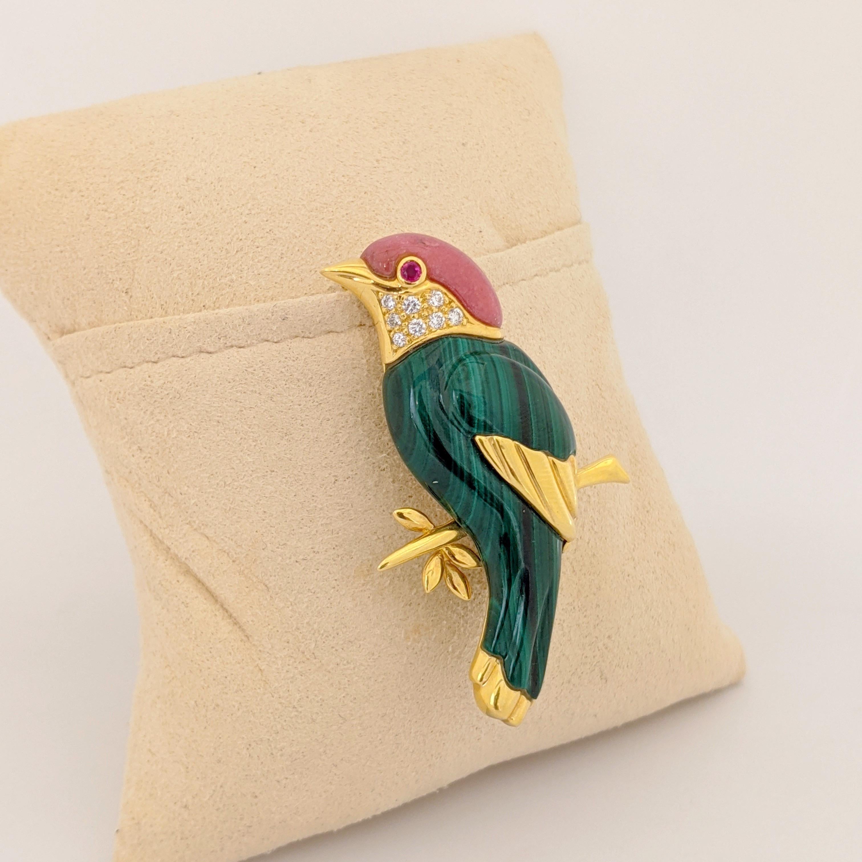 This lovely  18 Karat yellow gold Sparrow brooch is artfully crafted with carved Malachite , Pink Agate, and Diamonds. The sparrow has a ruby eye. The length of the brooch is 2