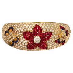 18 kt. Yellow Gold Wide Bangle Bracelet With Diamonds, Rubies, Sapphires