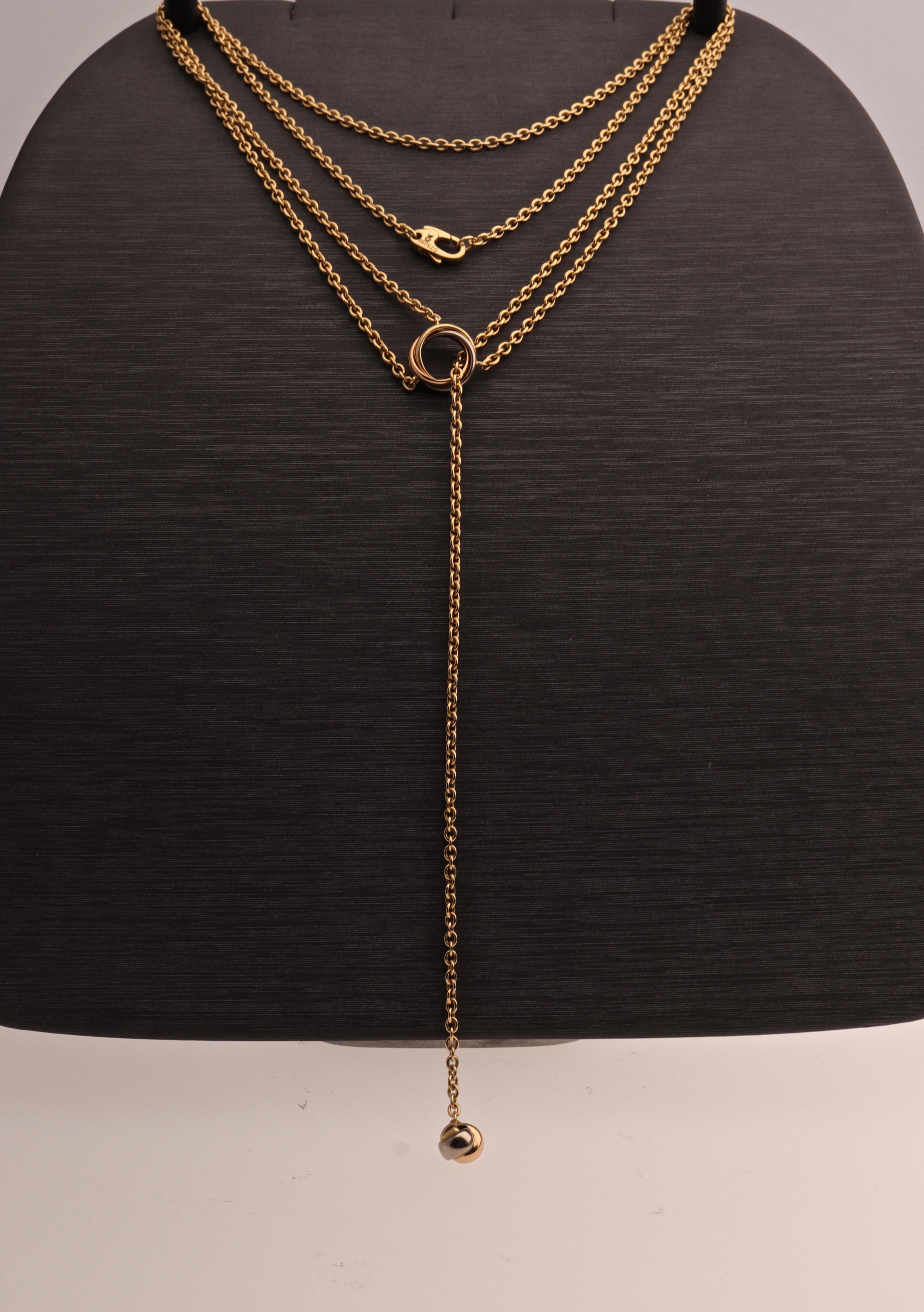 18 kt. yellow, rose, white gold necklace signed by Cartier.
This necklace has an interlocking gold ring where the chain goes through.
Is from the Trinity Collection,  contemporary and stylish.