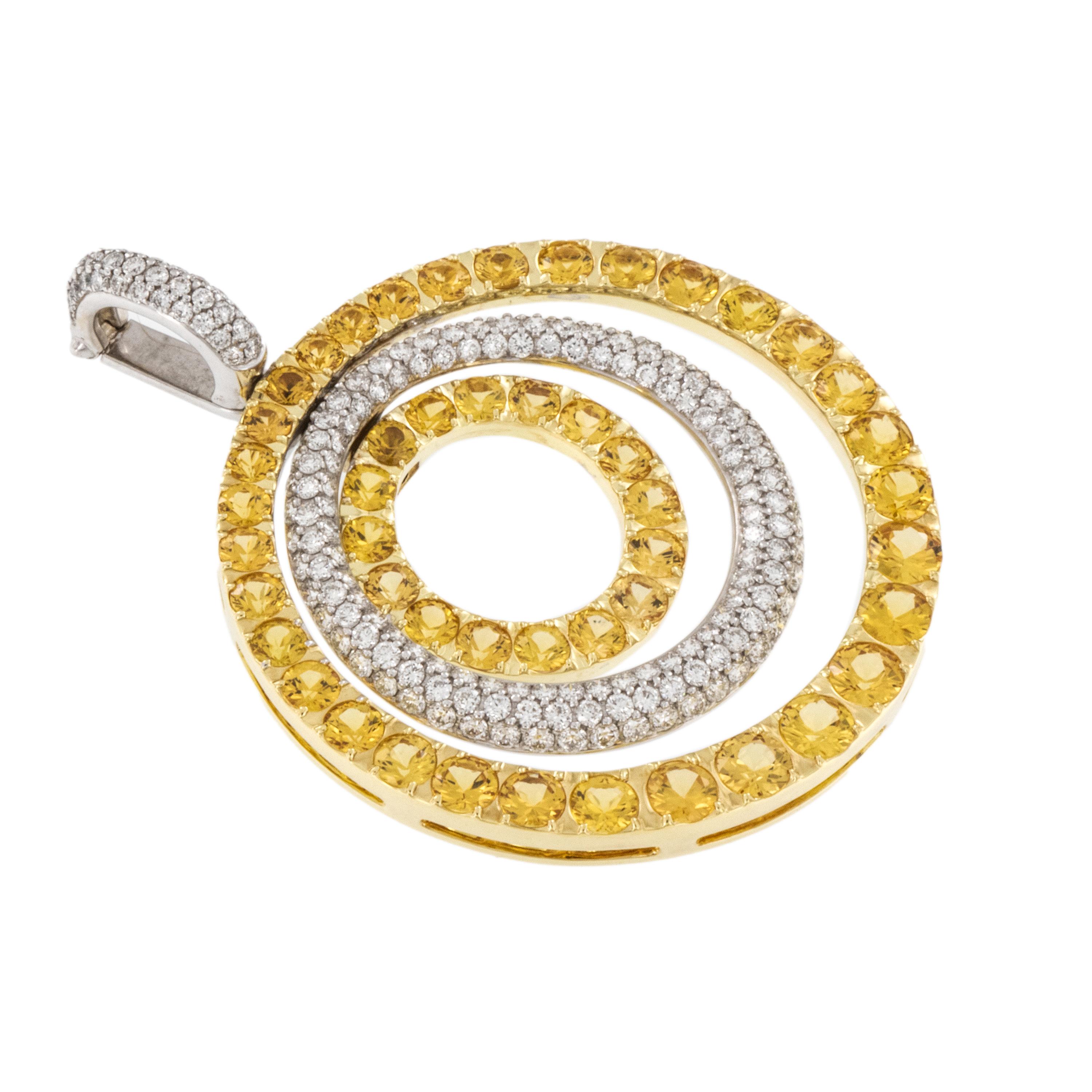 This impressive three rowed concentric circle pendant is like wearing sunshine around your neck! Crafted from 18 karat white & yellow gold the pendant is adorned with 48 yellow sapphires = 5.47 Cttw & 187 white diamonds = 1.59 Cttw. for a lovely and