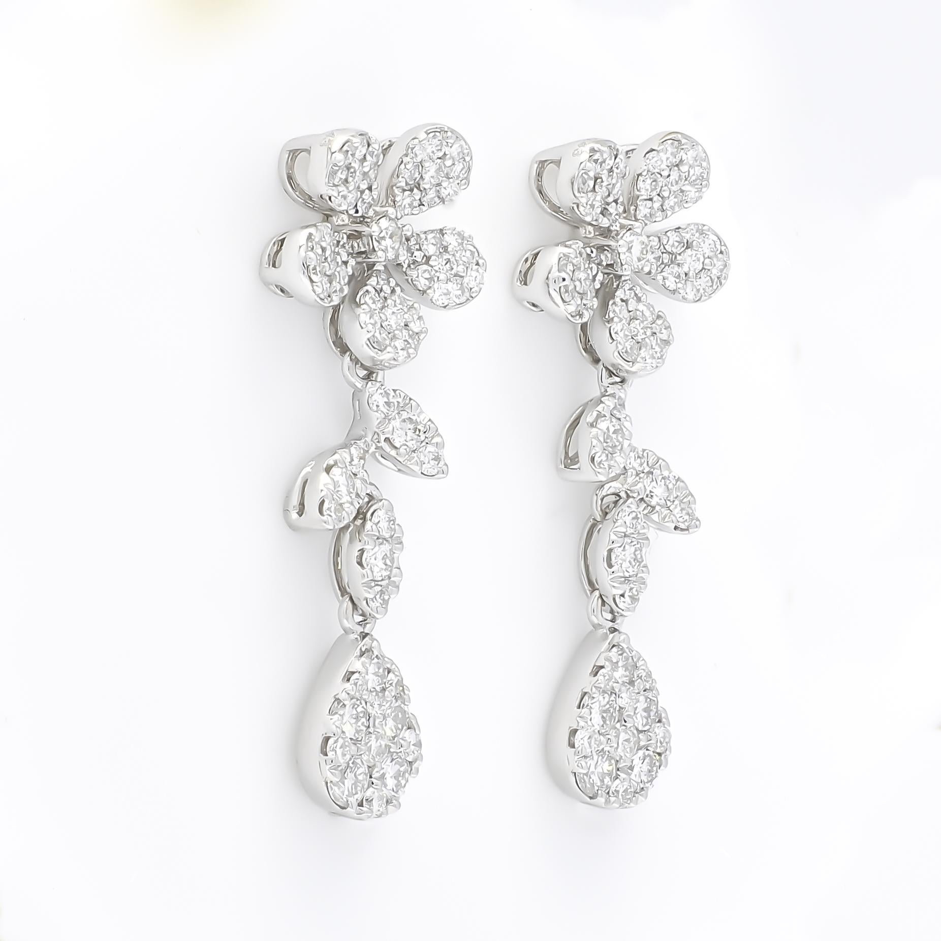 Be Dazzled by these flower clustered earrings set in 18KT White Gold. Fabulously floral.

Look fabulously floral in this sparkling beauty of these round-shape diamond elongated cluster drop earrings set in 18k white gold. It's all about the glam