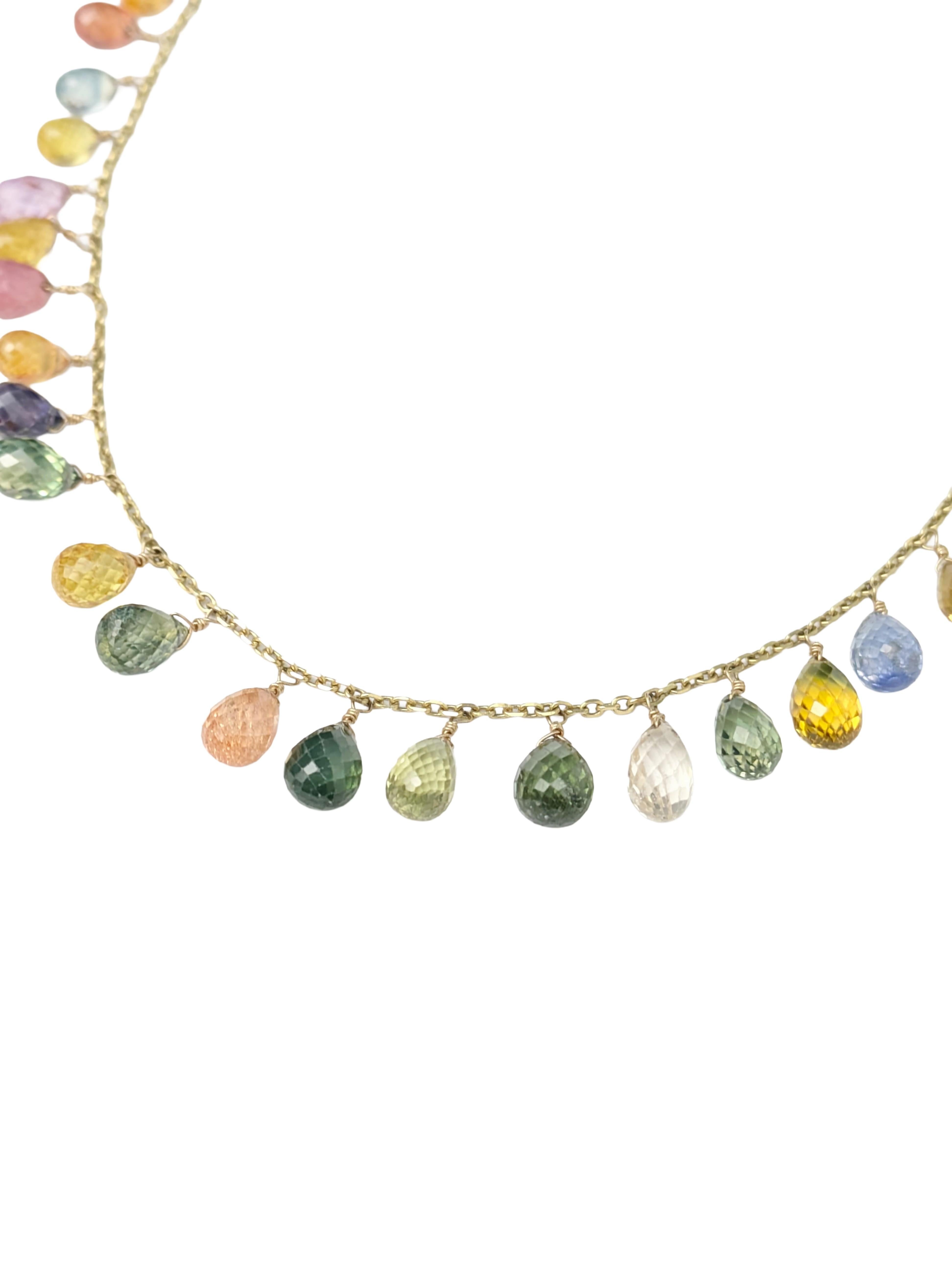 A cascade of color and light — this necklace features a vibrant array of natural multicolor sapphire briolettes, each hand-selected for its brilliance and hue. The sapphires are artfully arranged and hand-wrapped in 14K yellow gold wire to create a