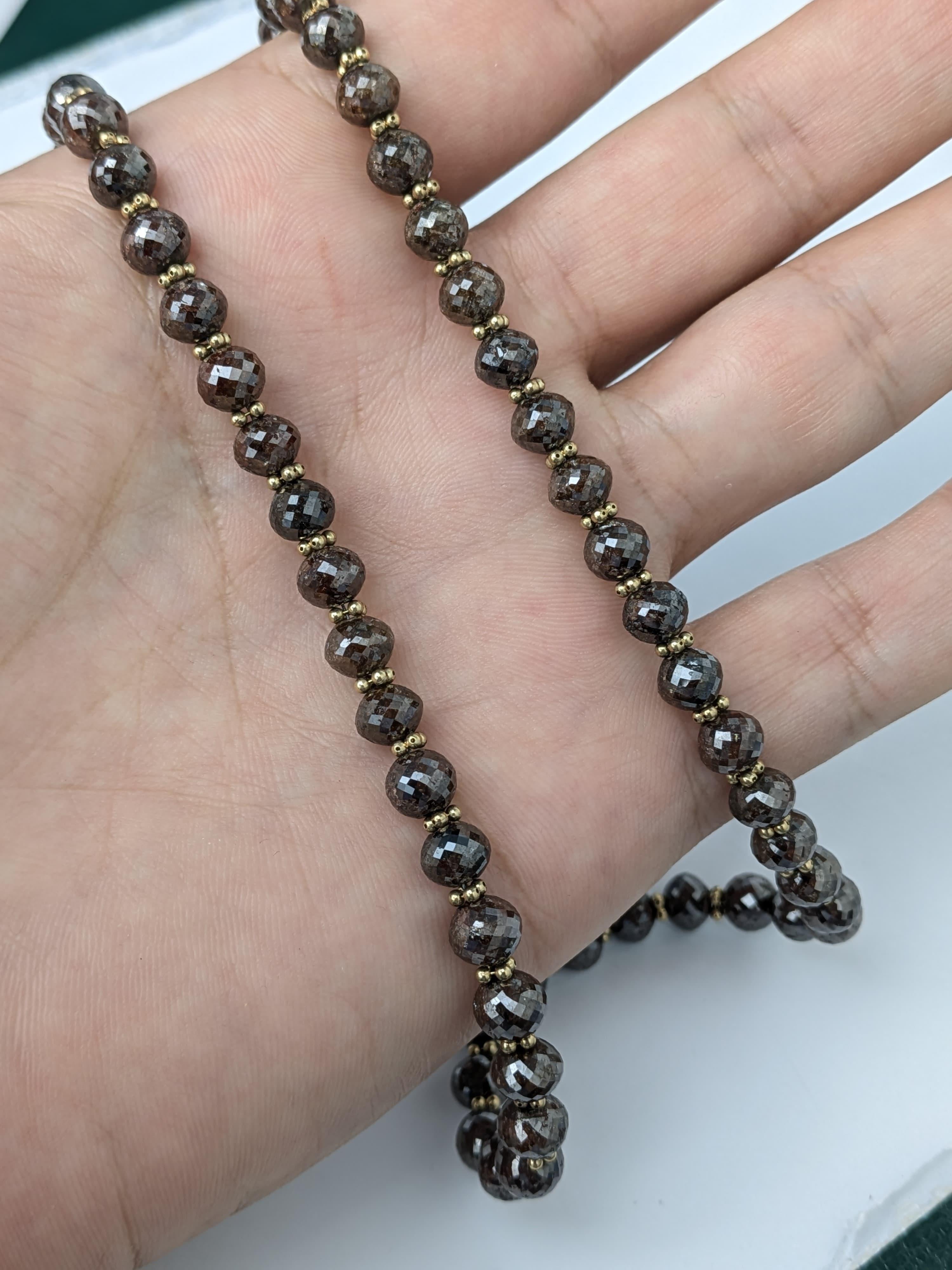 Ce collier de perles de diamants bruns allie une élégance riche et terreuse à un éclat radieux. Chaque diamant facetté capte magnifiquement la lumière, complété par des perles d'espacement en or jaune 14 carats et un fermoir en or jaune 14 carats.